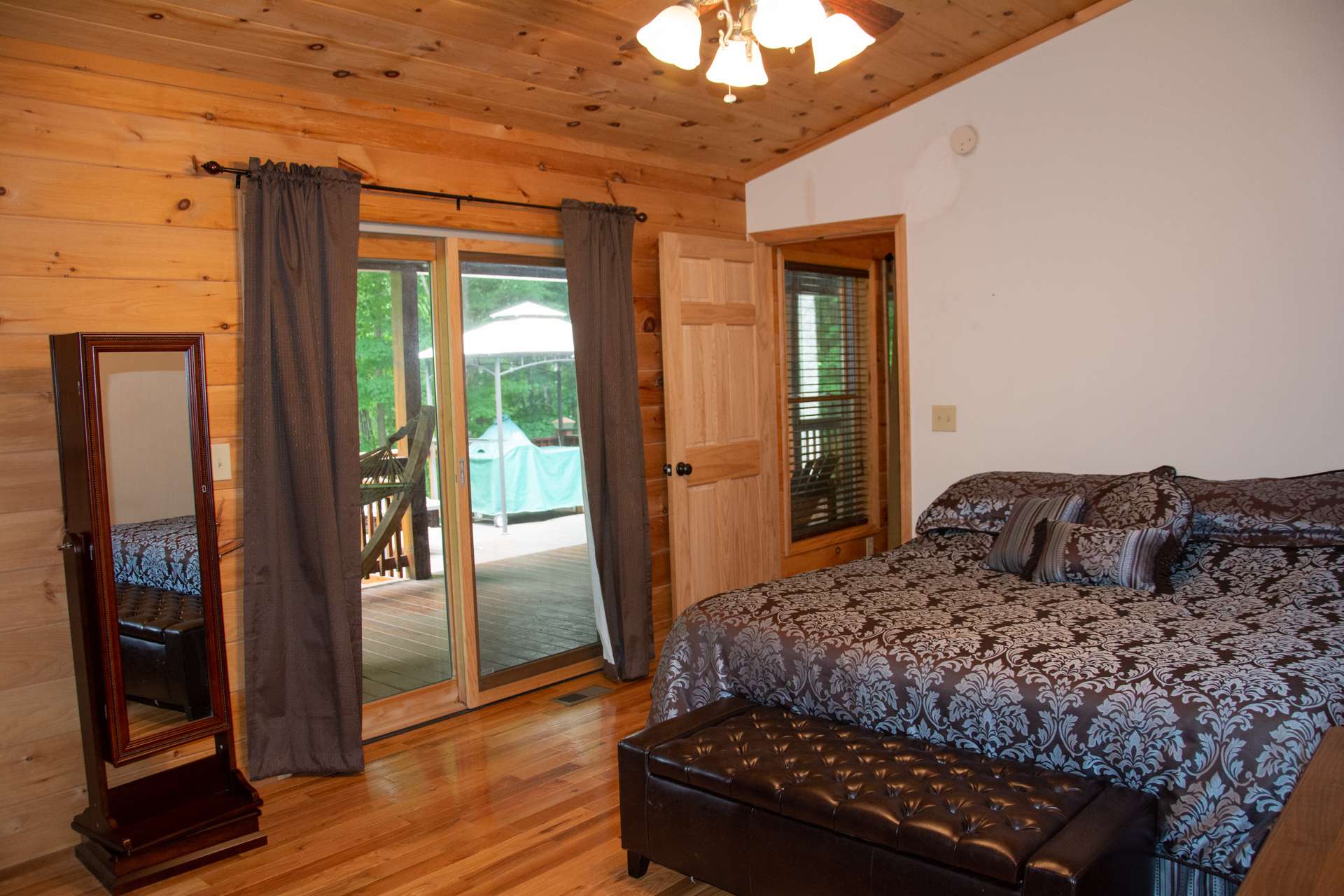 A split bedroom design gives the master suite more privacy and includes a walk-in closet,  a private bath, and access to the back deck .