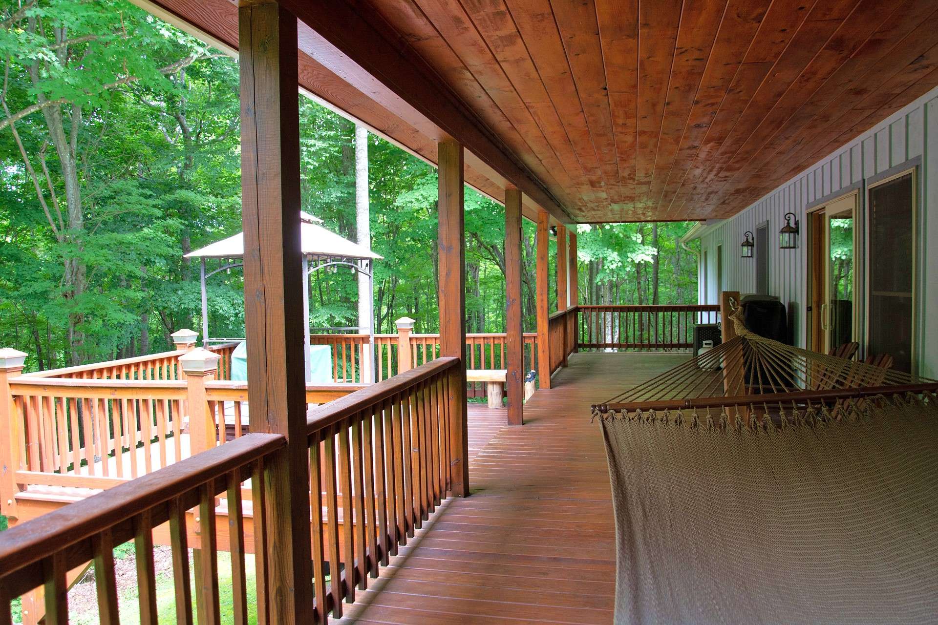 Relax and enjoy the peaceful surroundings on the back deck which has been expanded to offer both covered and open areas adding to the outdoor grilling, dining, and entertaining options.