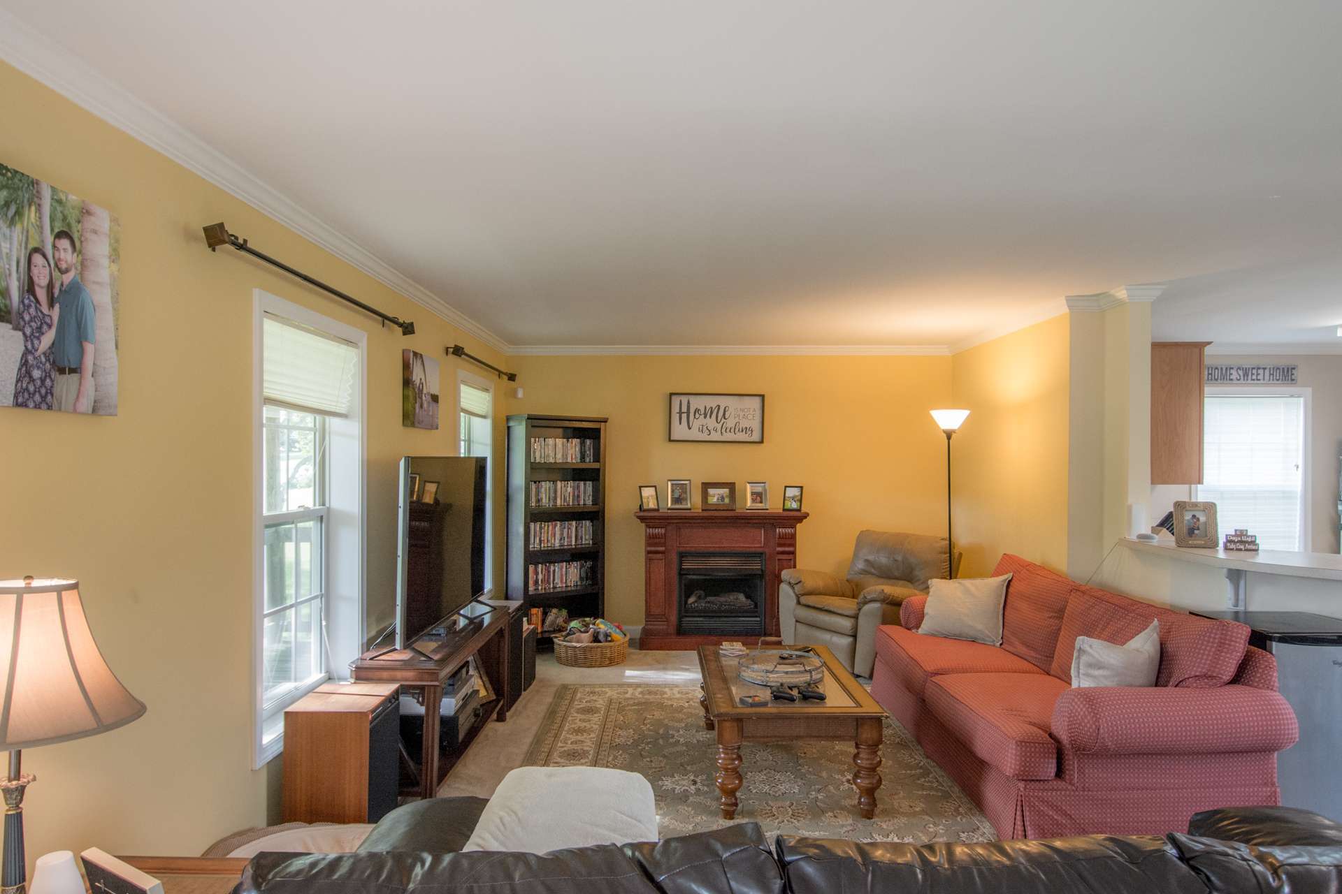 The main level features a bright and cheery living area with high ceiling, crown molding and open to the kitchen and dining area.