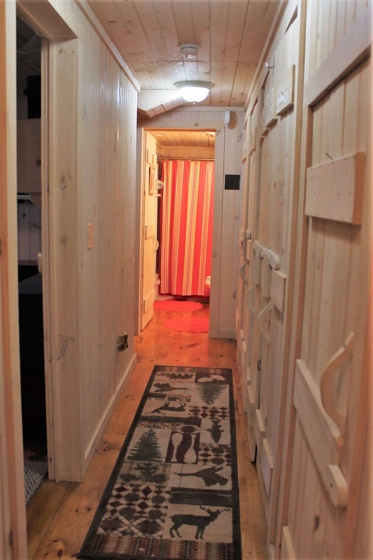 Lower level hallway has a wall of multiple closets providing abundant storage as well as a full size washer and dryer.