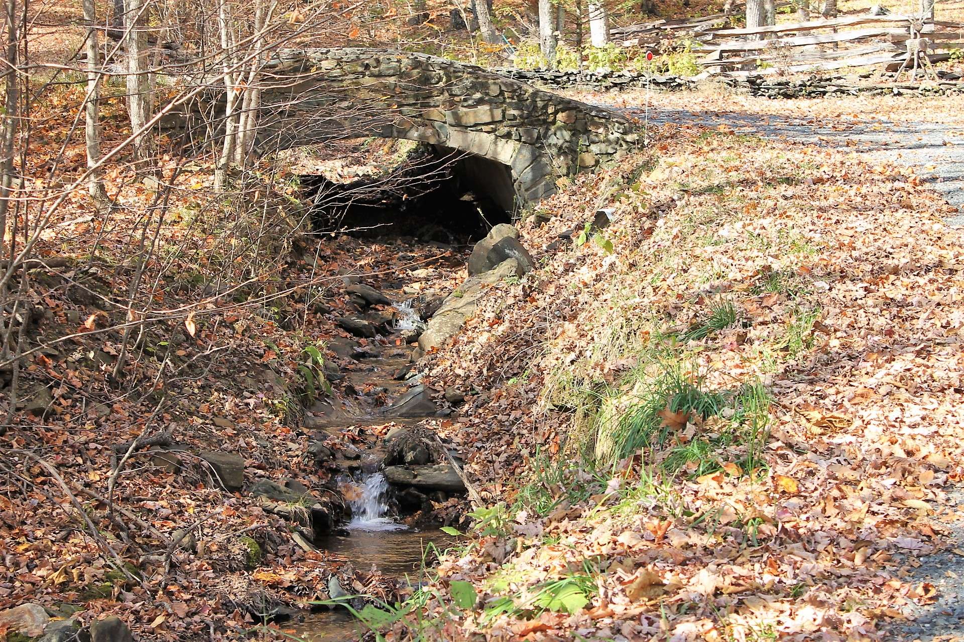 A babbling creek flows under one of the many stone bridges found in the community.
