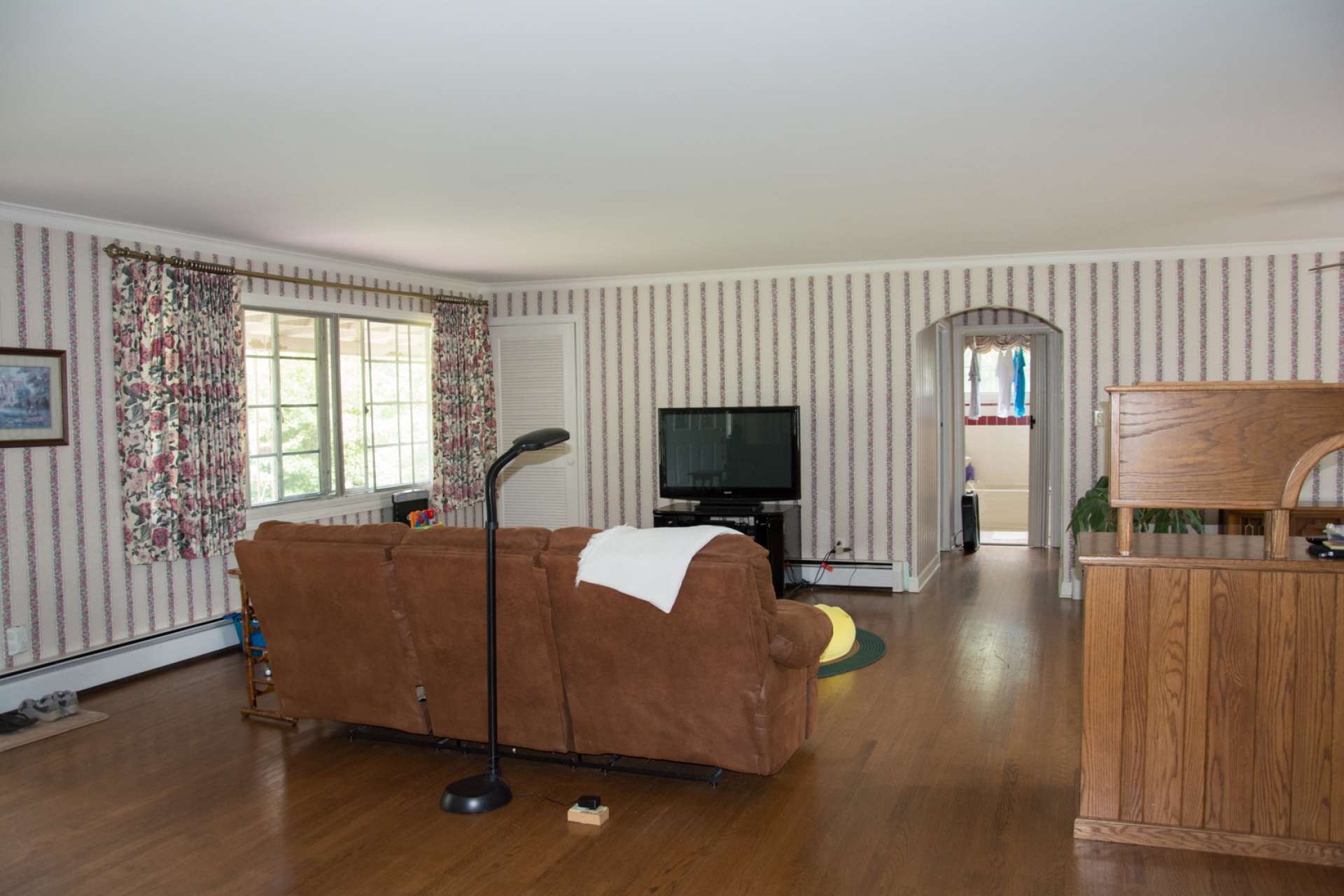 The main level offers a spacious living area with hardwood floors and a wood-burning fireplace.