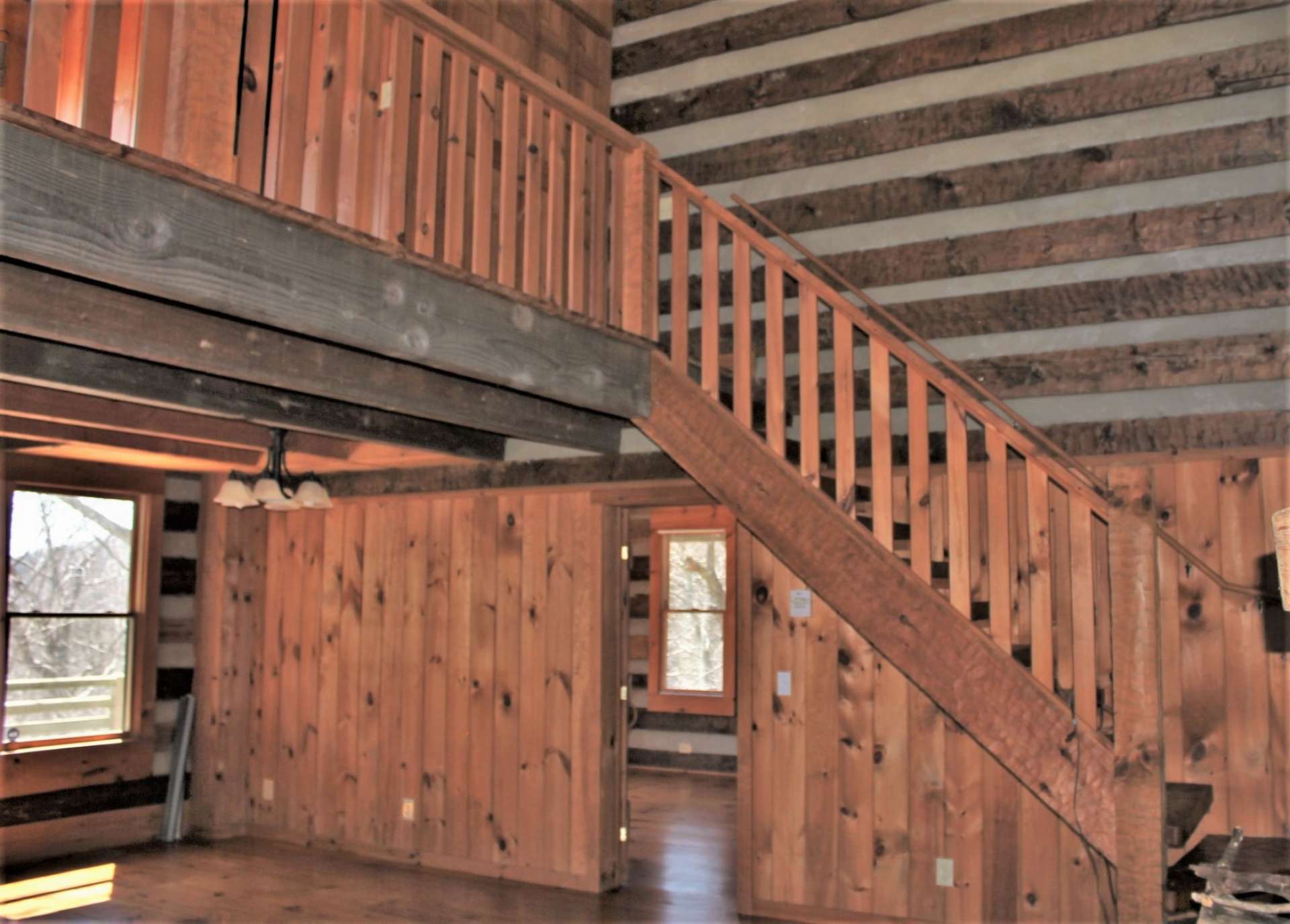 The hand-hewn staircase leads your guests to the bedroom loft area.