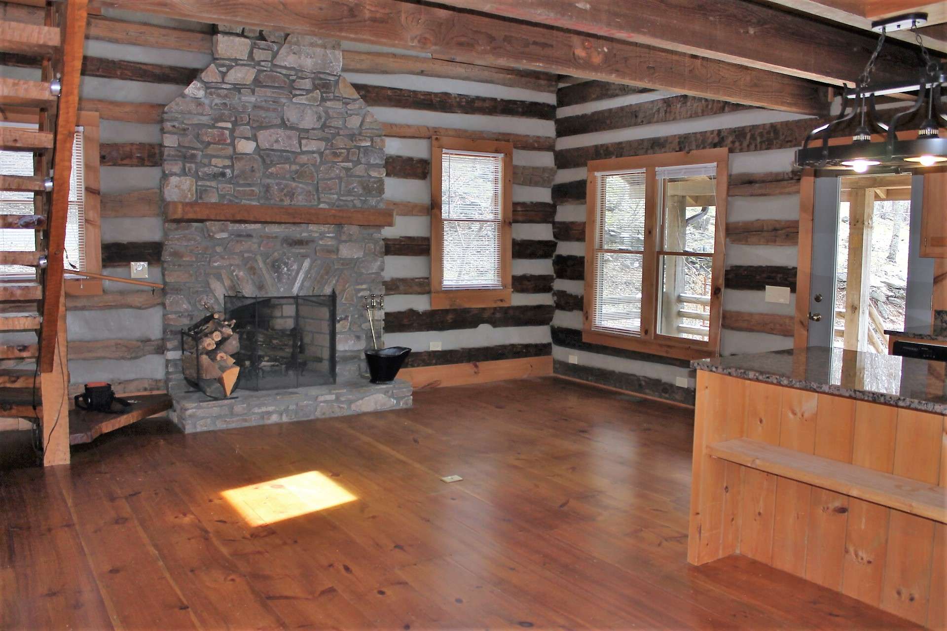 The interior features an open floor plan with wide-plank wood flooring throughout.