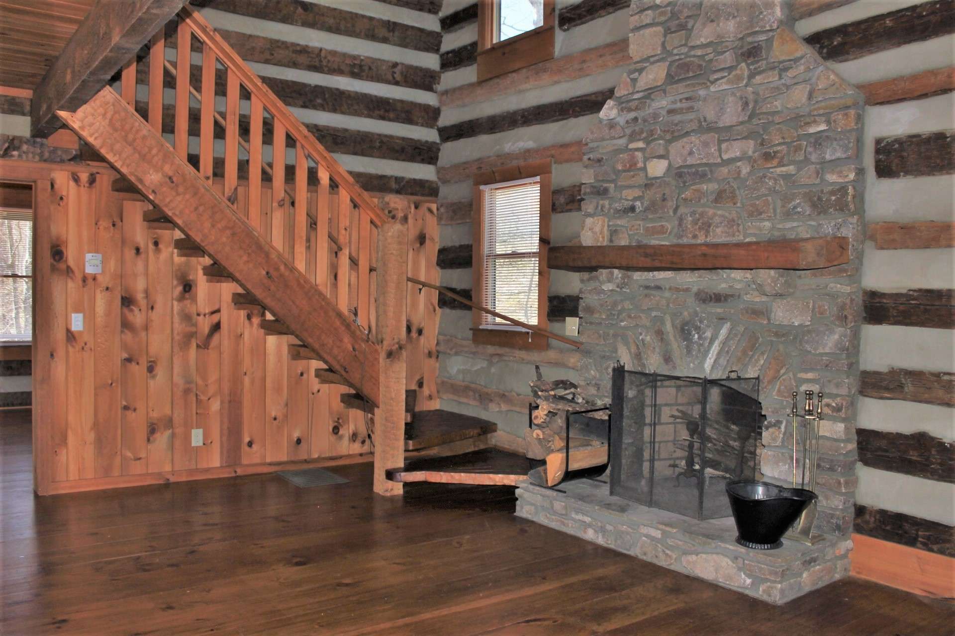 The great room is warm and inviting with rustic details that enhance the experience of log home living.