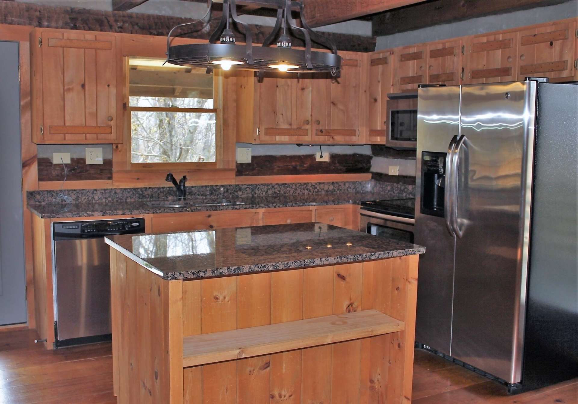 Kitchen is beautifully equipped with stainless appliances, granite counter tops, island and rustic custom cabinets.