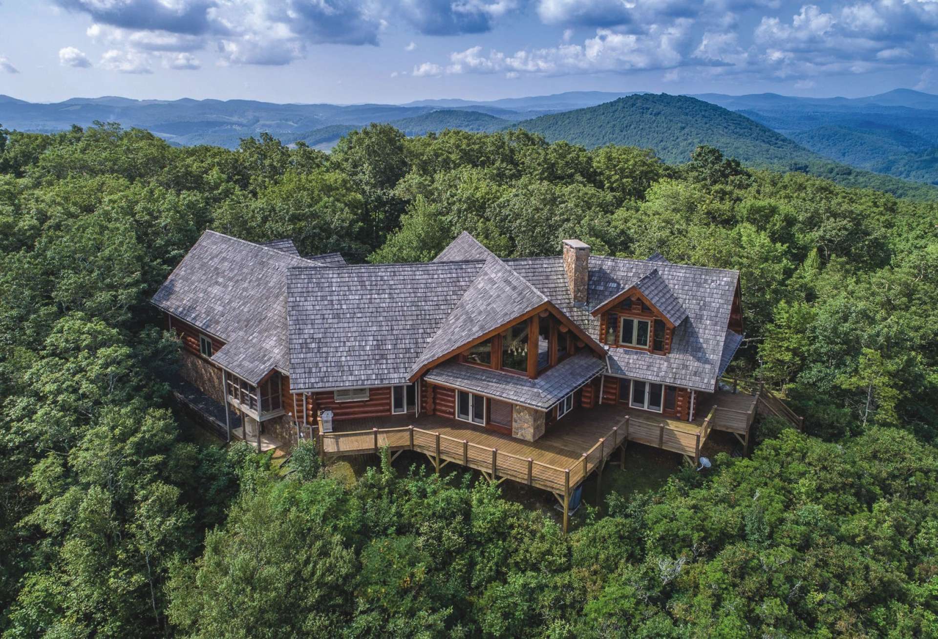 This one-of-a-kind mountain property is truly the ultimate mountaintop retreat or estate offered at $1,350,000 and includes the Architectural pleasing log home with 3 stone fireplaces, vast windows showcasing fabulous long range mountain vista views, 3-car garage, guest house, both homes offered furnished, and a private wooded 19.06 acre setting in the Laurel Mountain Estates community of the Todd area of Southern Ashe County. If you are looking for an extraordinary mountain property, call for more information on listing B160.