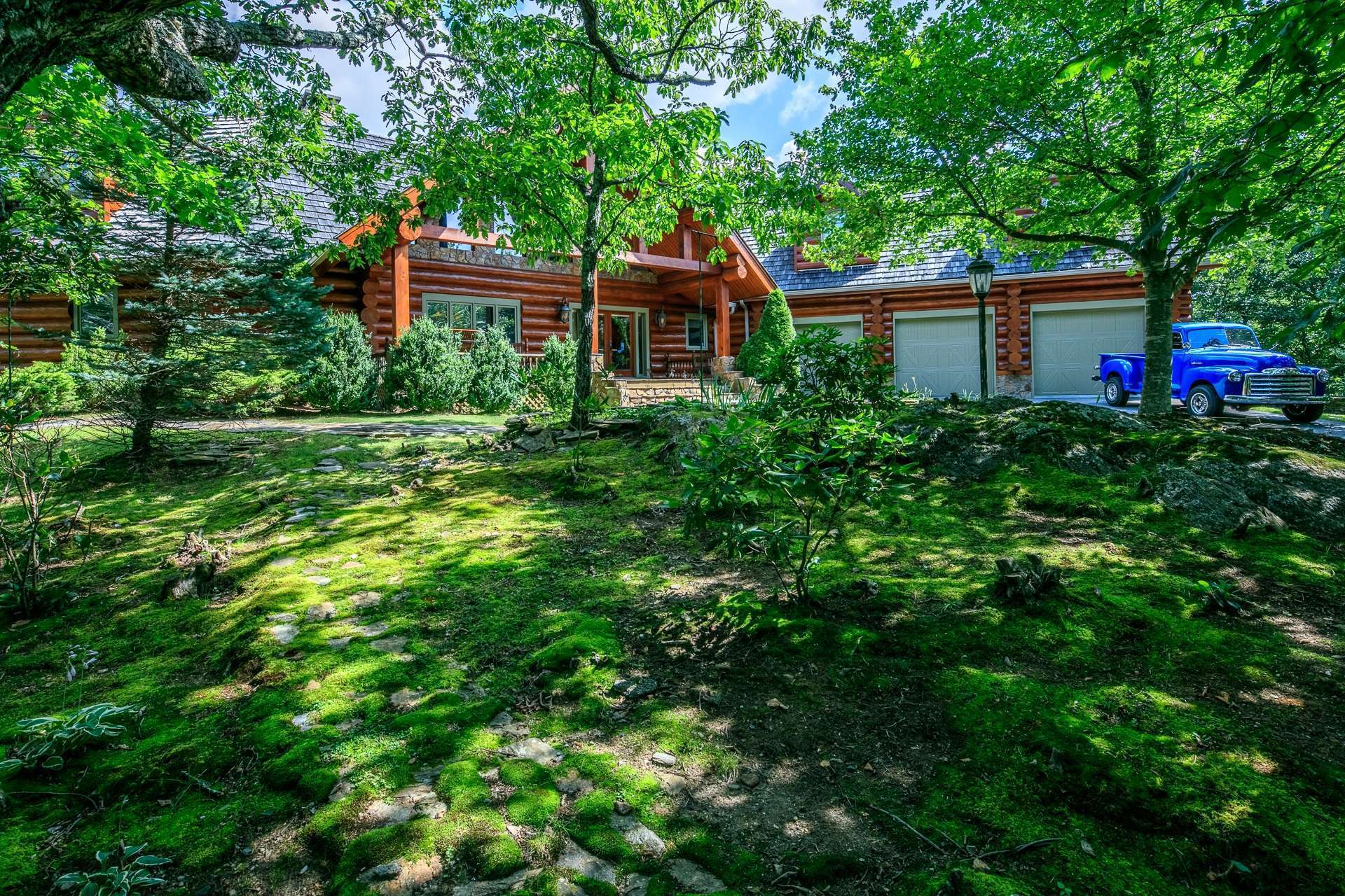 Majestically sited on a naturally forested 19.06 acre setting in the Todd area of Southern Ashe County, this log home offers fabulous curb appeal and plenty of parking space including a three car garage.