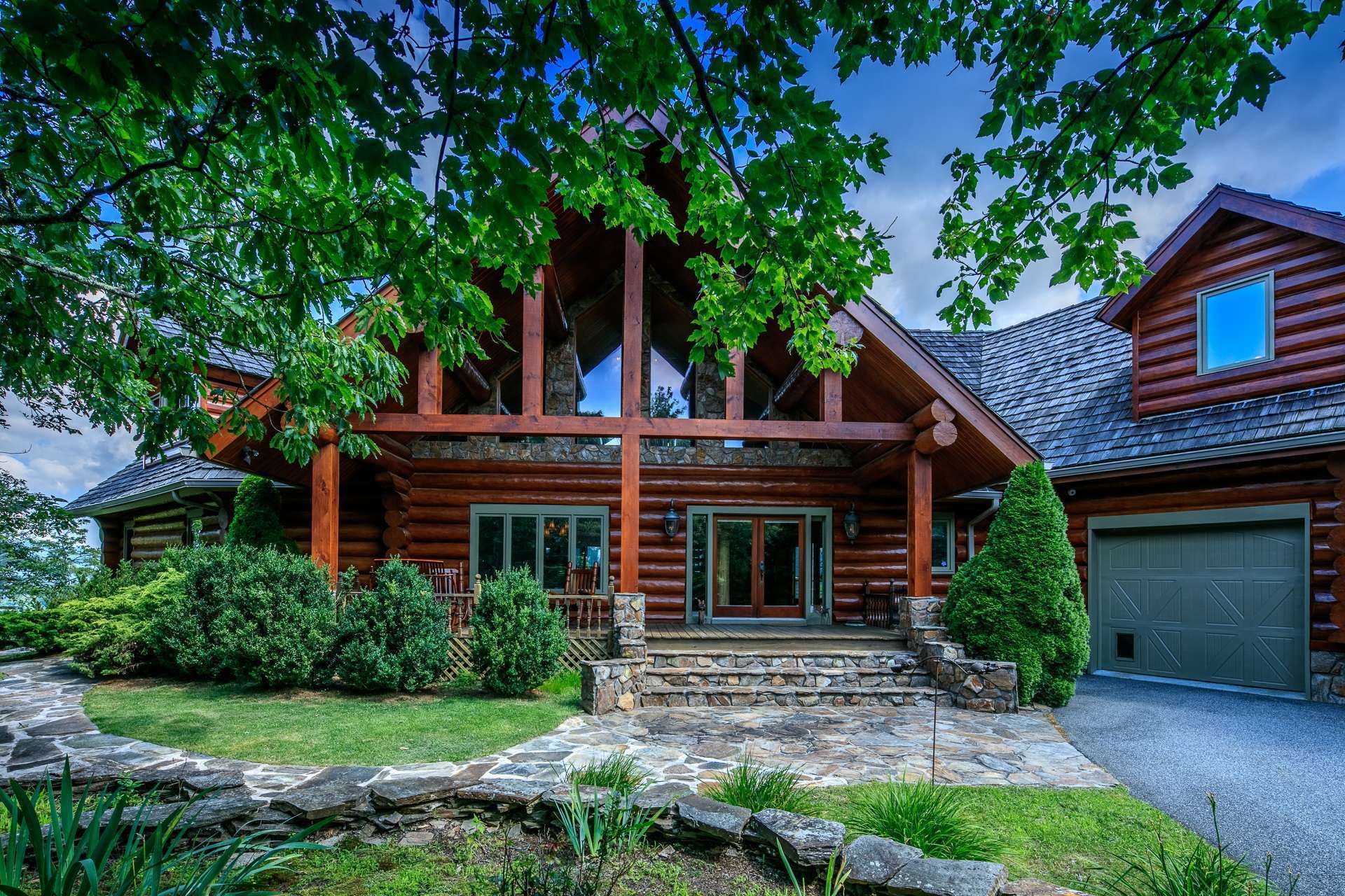 A stone walkway leads you to the covered vaulted front porch beckoning you to sit and relax before entering the home and the many custom details that await you.