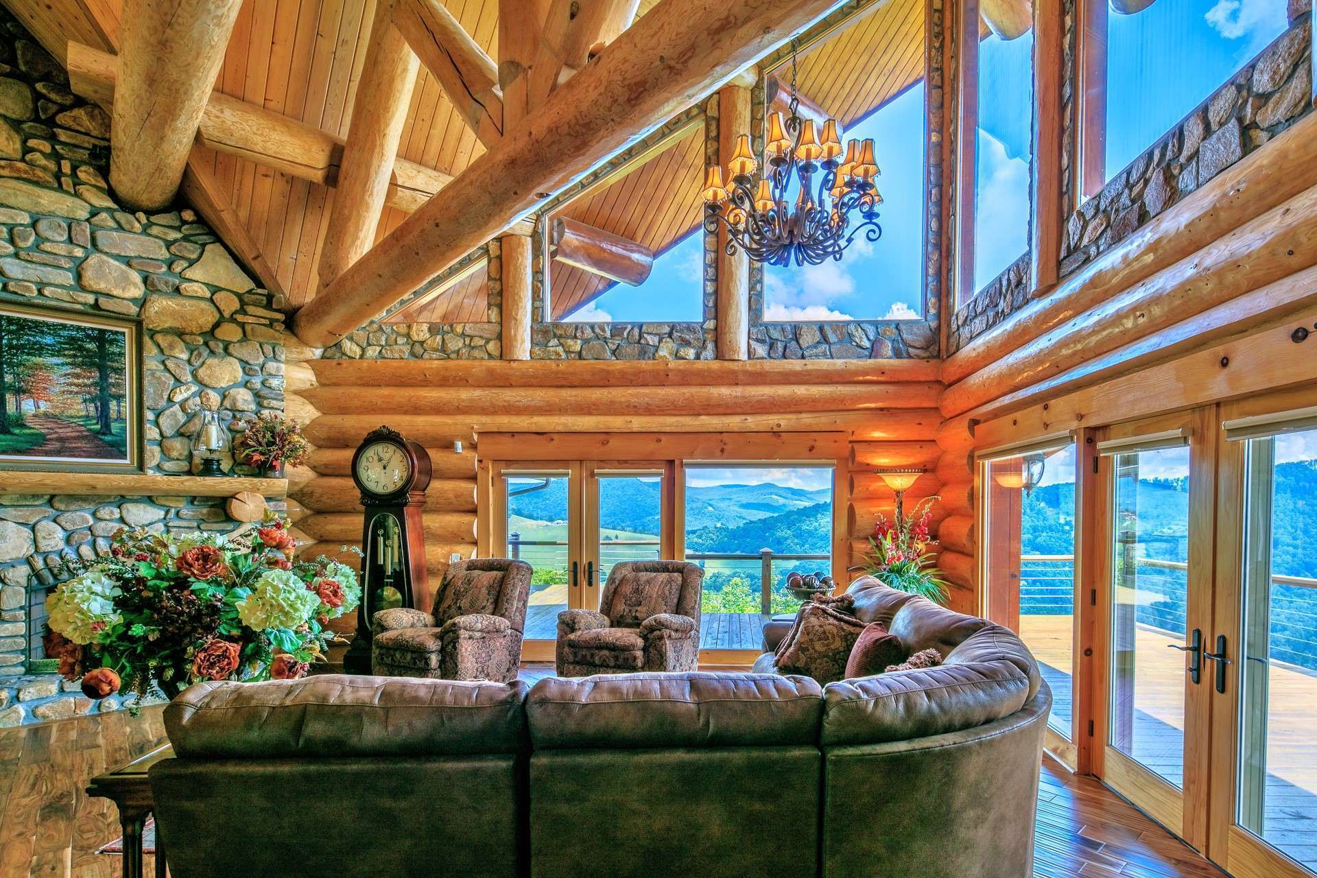 The high vaulted ceiling highlights the exposed log beams while the vast wall of windows fill the cabin with natural light and enables you to enjoy the great outdoors throughout all four seasons in the majestic Blue Ridge Mountains.