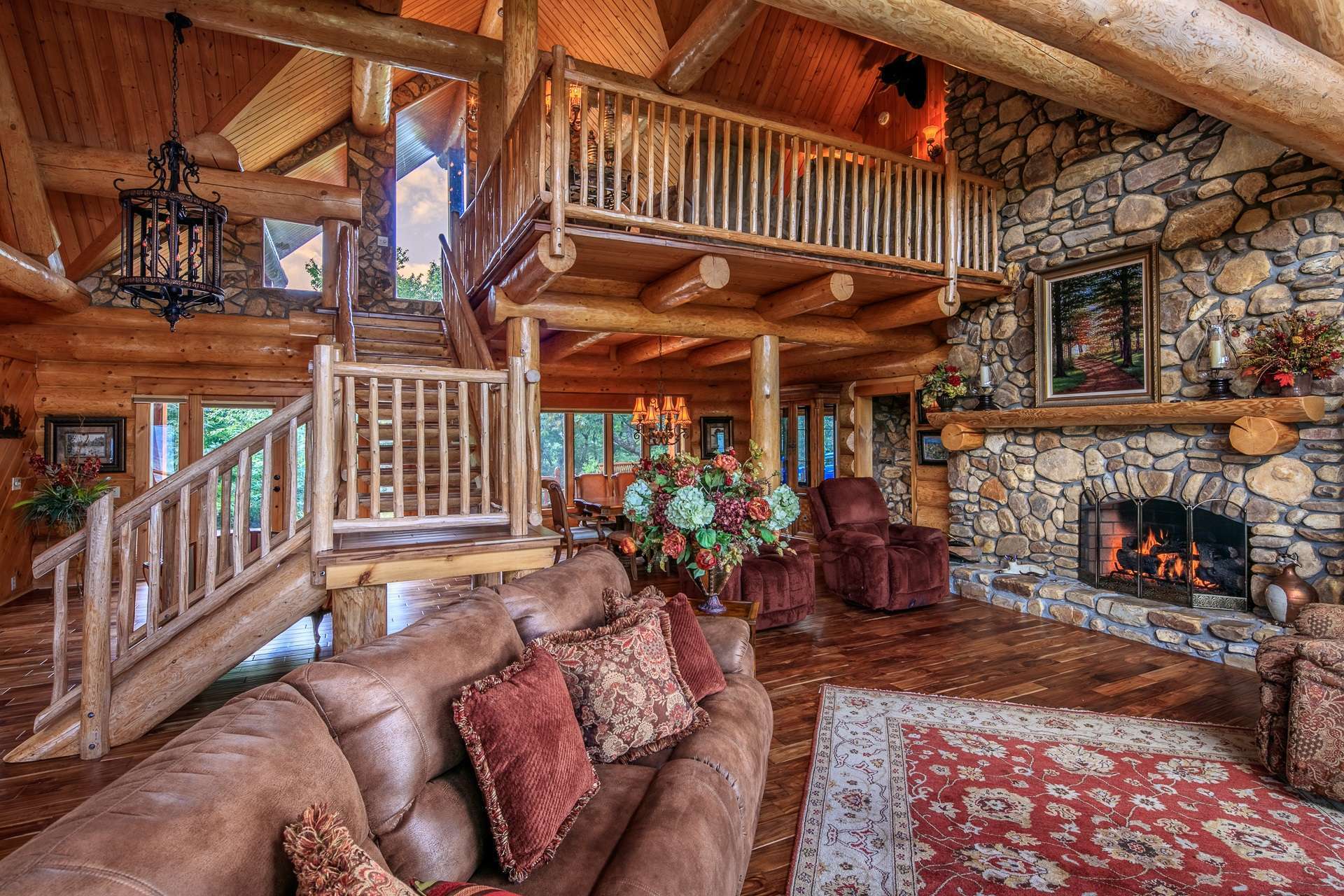 The captivating vaulted great room is designed to embrace both rustic and elegant details with the focus on the massive 2-story stone fireplace and the tremendous views.