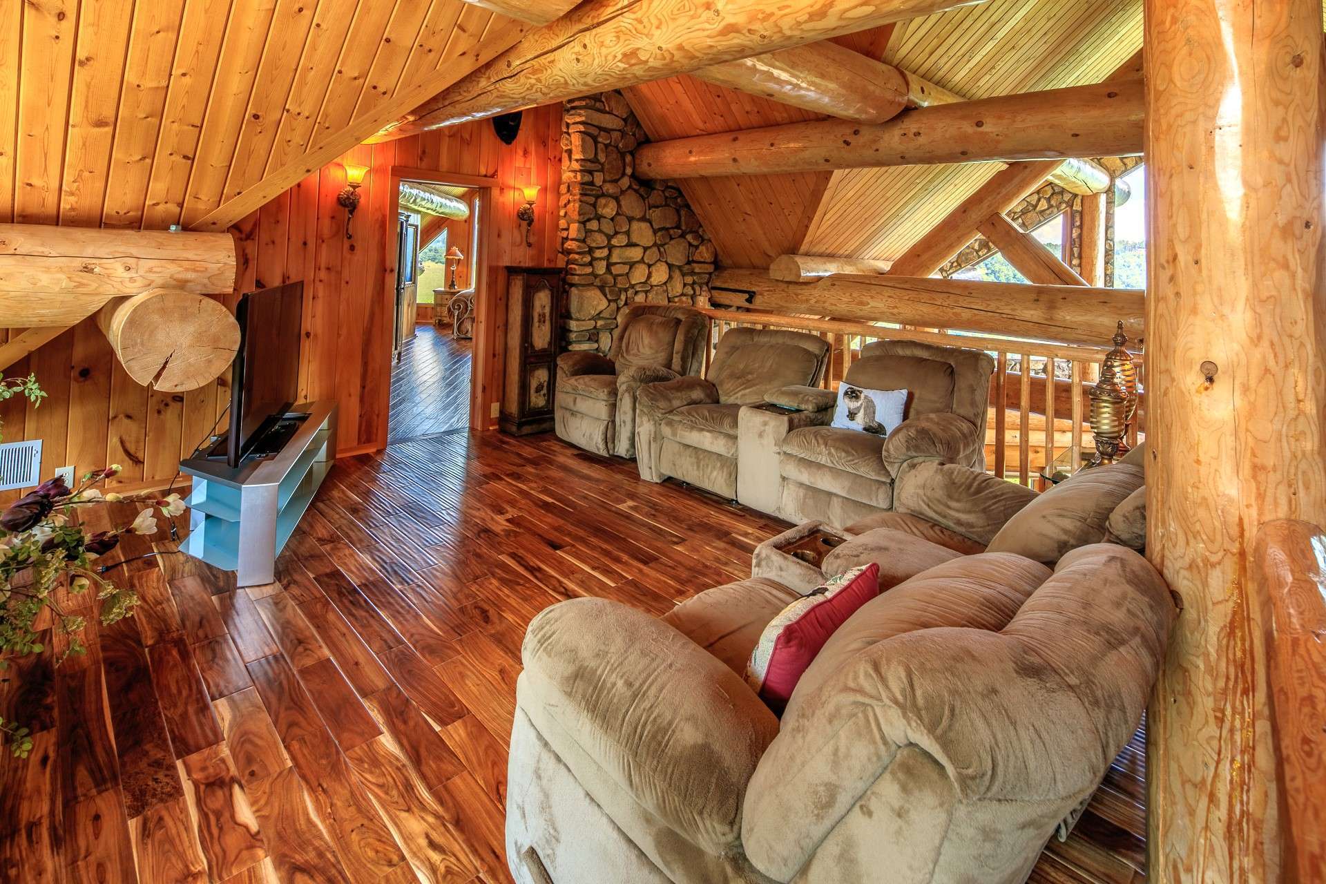 The upper level offers two areas of living space. The open loft area is ideal for sitting area or library. Notice the architectural interests available here.