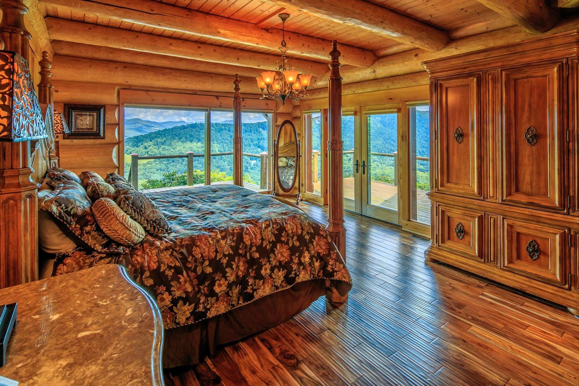 The main level owner's master suite maintains an ambiance that exudes warmth and charm. Large windows along with French doors flanked by more windows provide natural light and access to the deck, while...