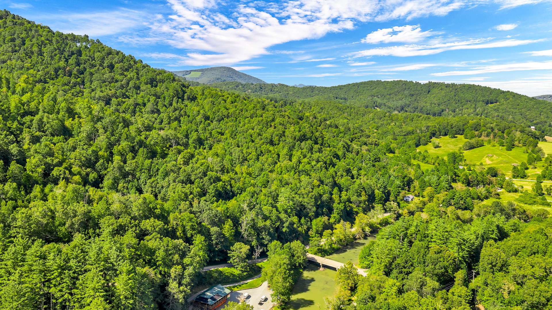 The surveyor who marked the corners said this land lies perfectly for development or for a private mountain homesite.