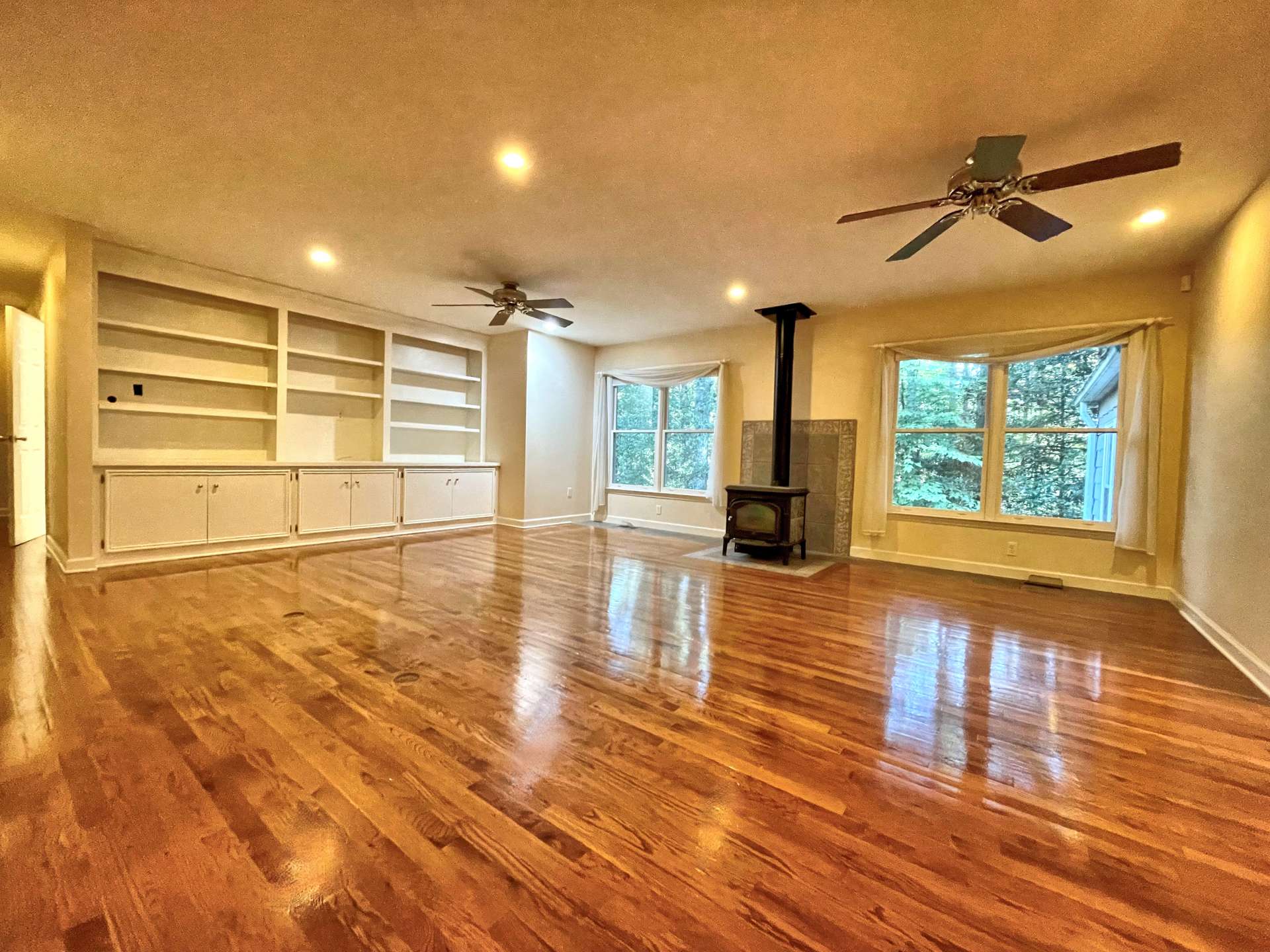 Large Family room with wood burning fireplace and built-in cabinets.