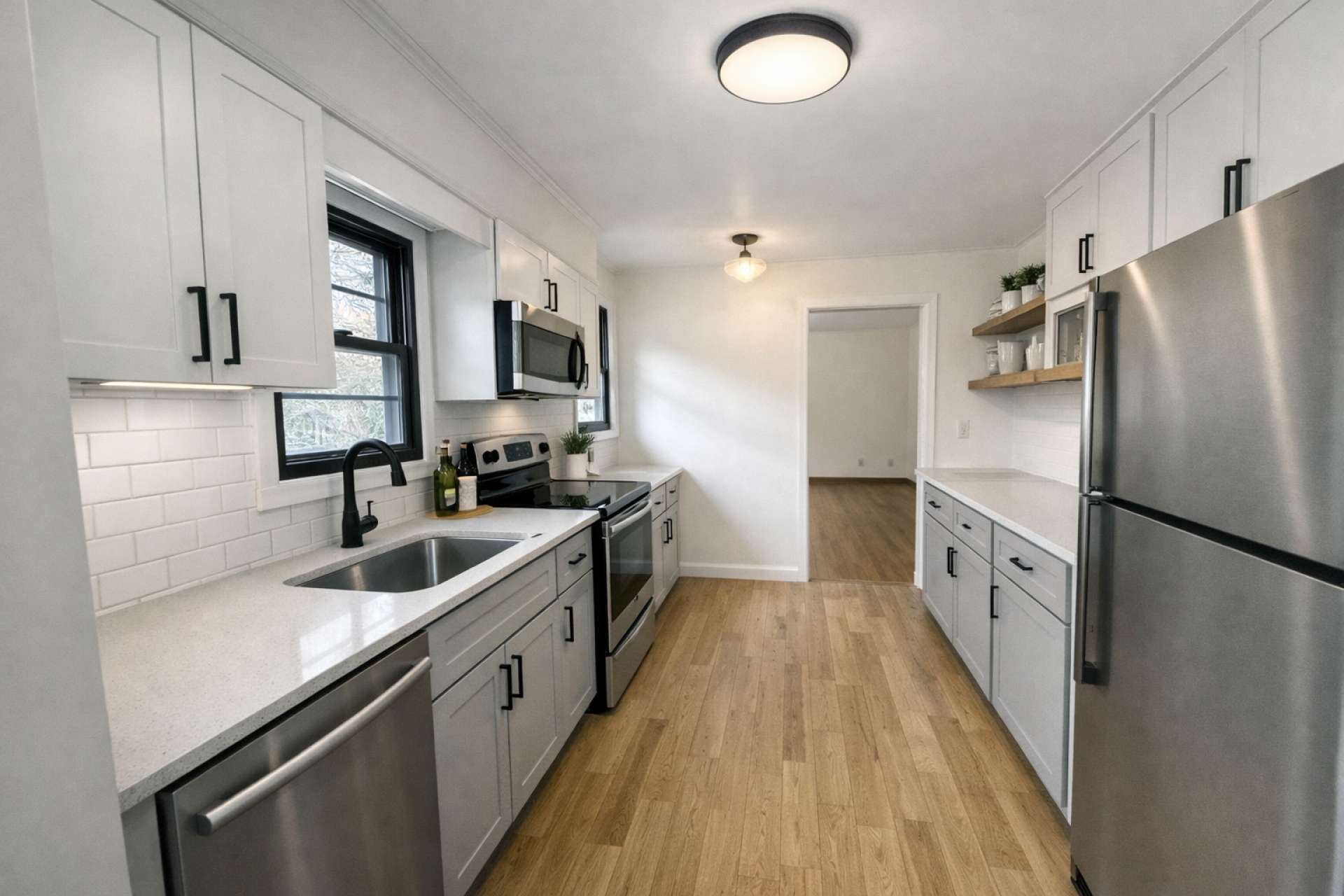 This is another virtual-generated photo showcasing how nice this kitchen can look with just a new coat of paint, updated lighting, cabinets, and appliances.
