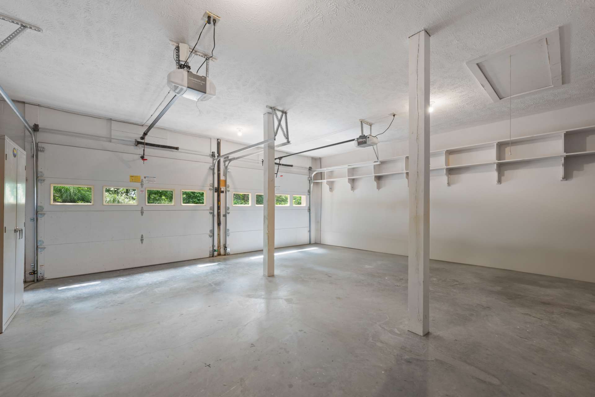 The spacious two-car garage provides extra room for tools and gear, with an attic space above for easy seasonal storage.