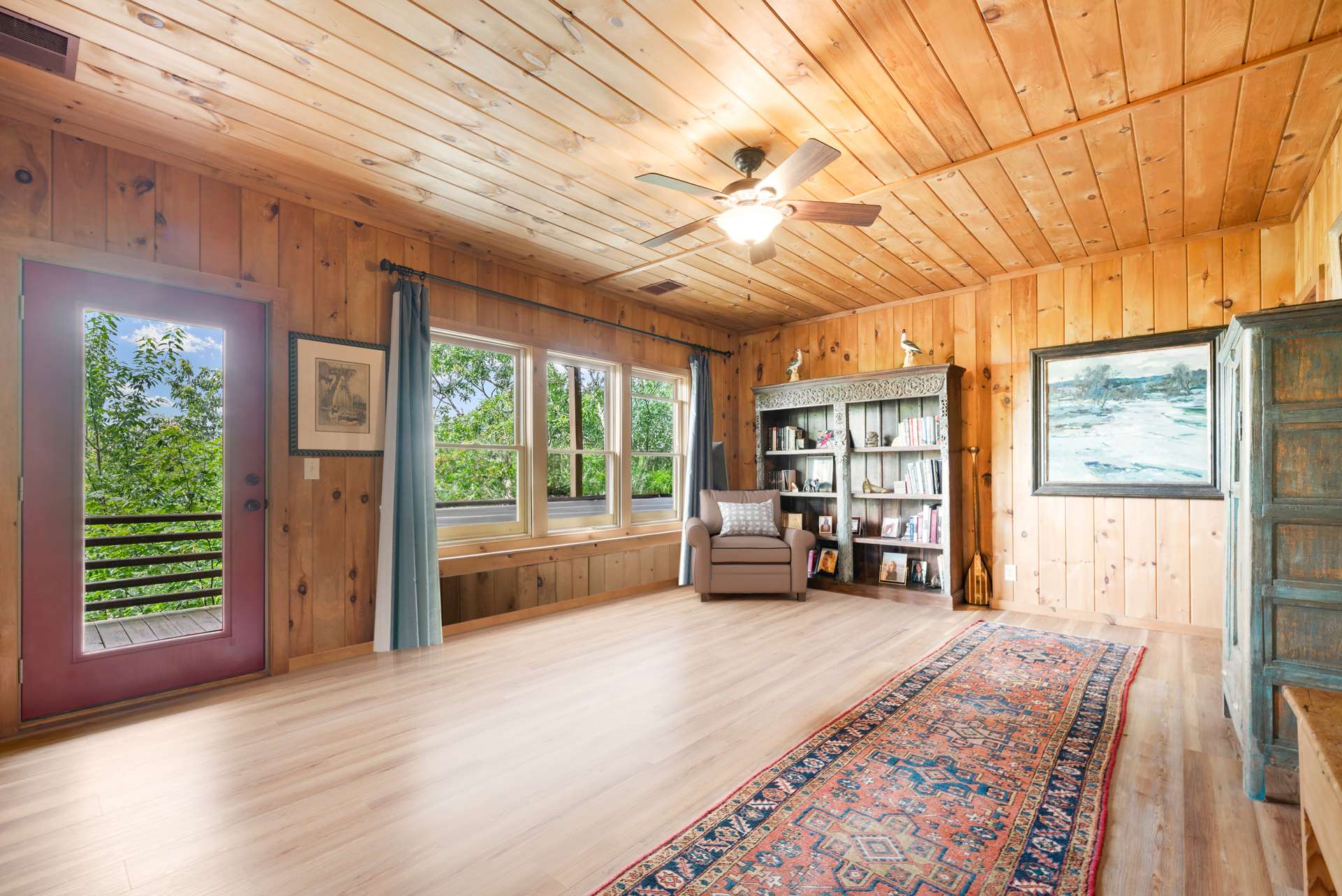 The lower-level family room creates a flexible living space with room to lounge, work, or play, opens directly to the lower deck and hot tub.