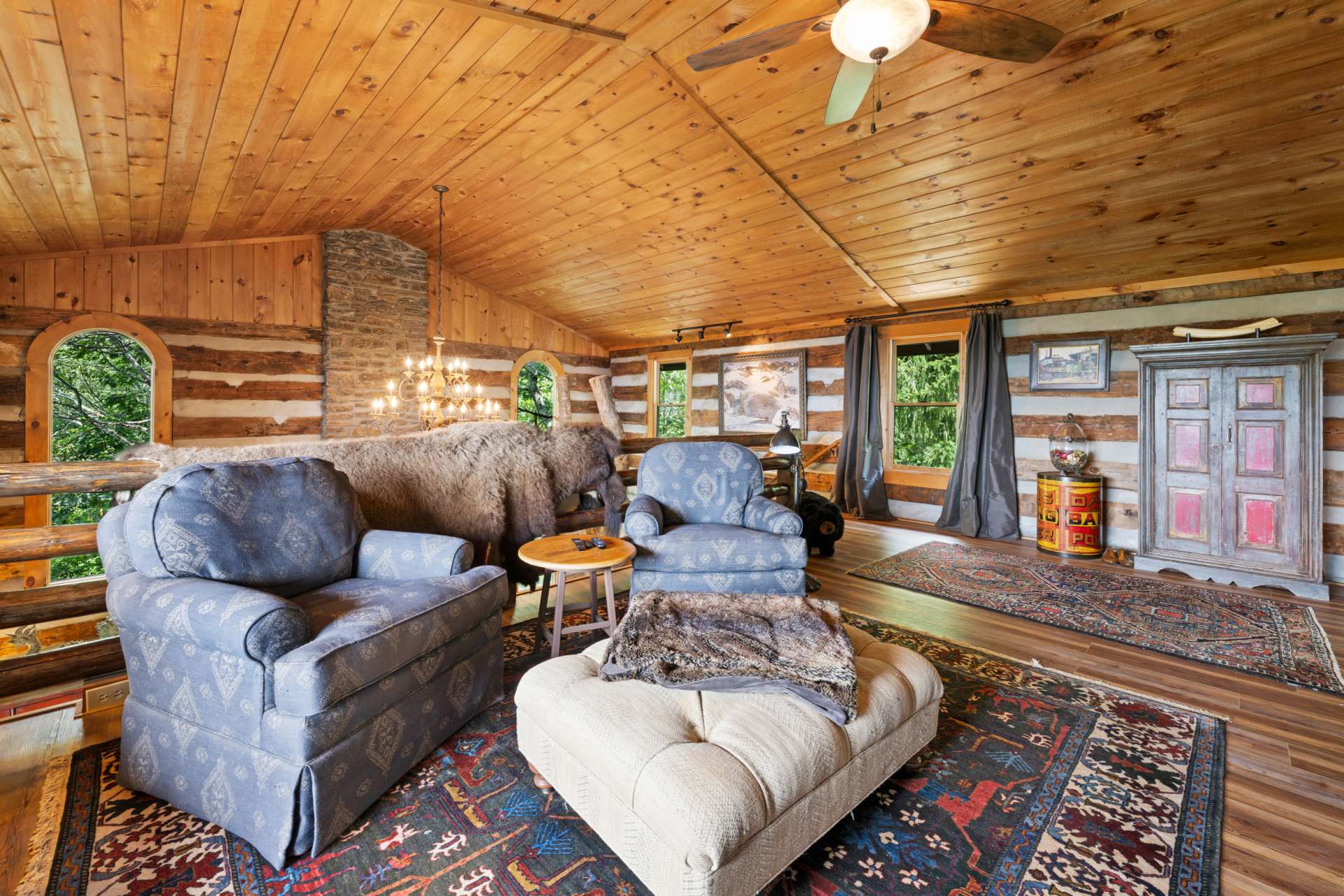 The open loft adds versatility and charm, offering a bird’s-eye view of the great room and fireplace below.