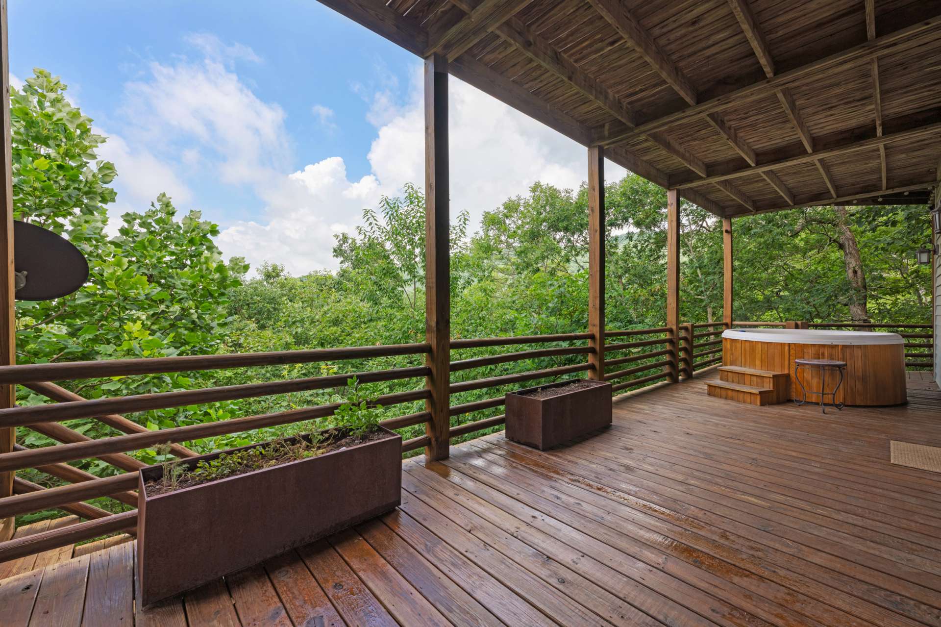 The lower-level private deck, nestled in nature, feels like a secluded spa, perfect for soaking in the hot tub while admiring a brilliant celestial show.