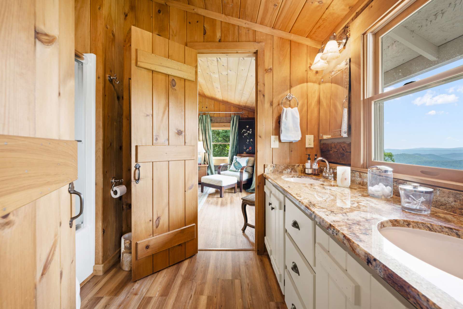 A Jack-and-Jill bathroom with granite countertops and double sinks connects the two spacious upper-level guest suites.