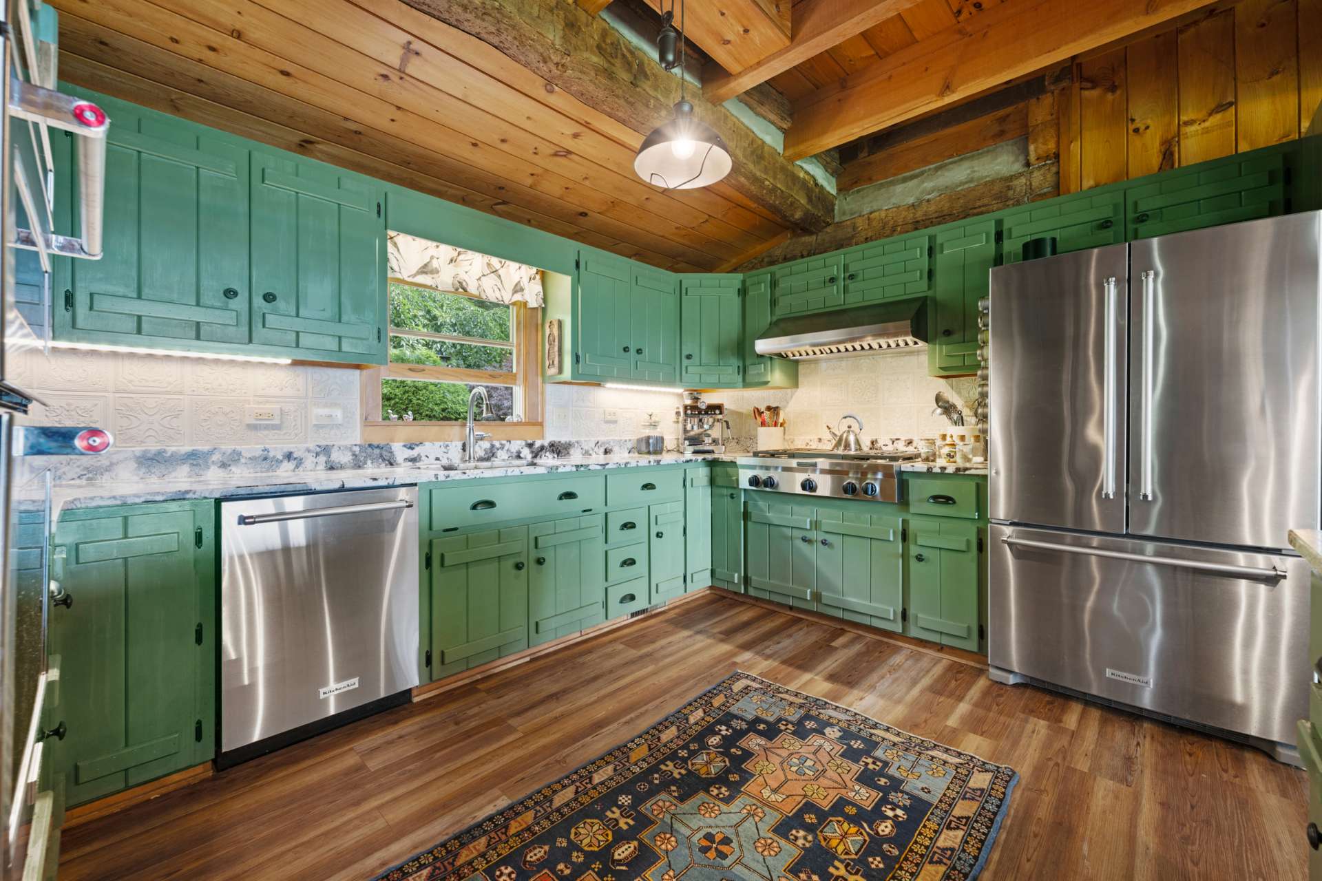 This thoughtfully designed kitchen features high end leathered granite countertops with a unique backsplash that brings depth and brightness to the space. Modern stainless gas cooktop, wall oven, built-in microwave with convection feature and spacious refrigerator make this a chef's dream come true!