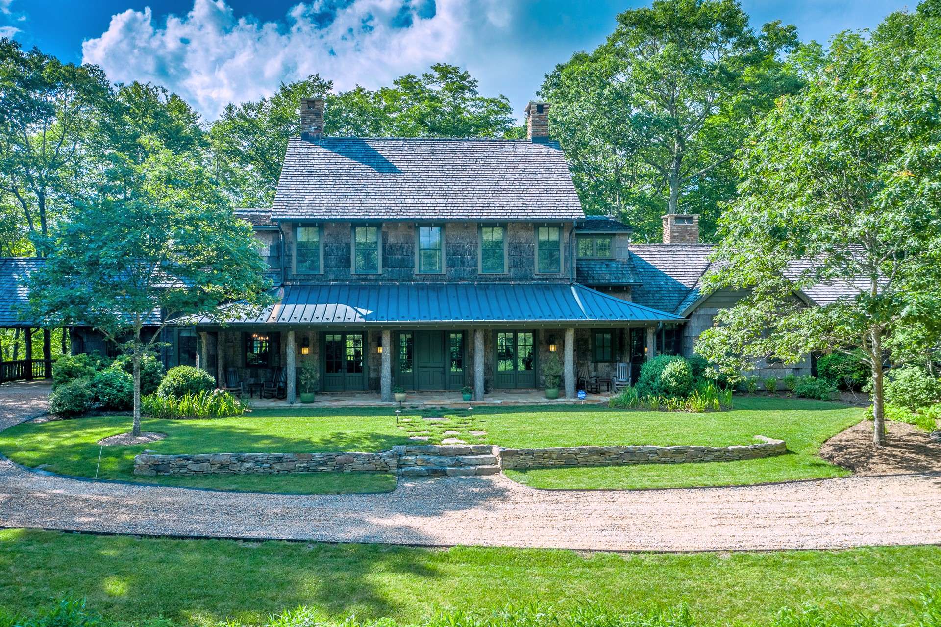 The poplar bark exterior, cedar shake roof with copper roof over porches, copper gutters and numerous Pella windows & doors create a stunning exterior and welcoming entry as one approaches the house by the private driveway.