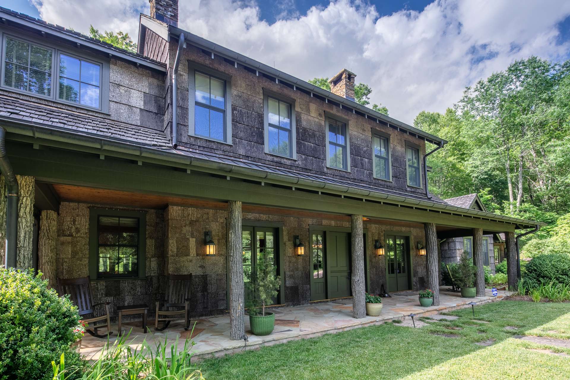 Outdoor living is augmented by full length covered front and back porches with a portion screened-in on the back offering a wood-burning fireplace.