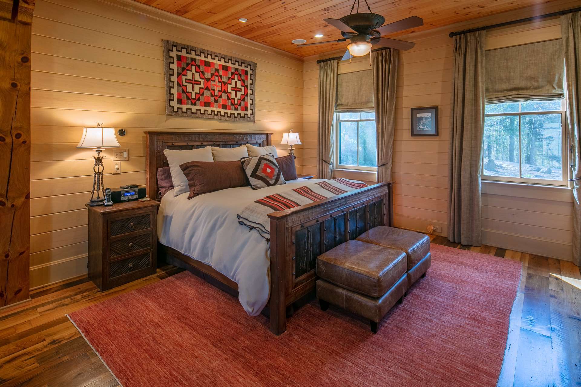 The master suite is situated on the main level and is its own mini-sanctuary, complete with another stacked stone fireplace, sitting area, refreshment station, spacious walk-in closet and its own covered porch.
