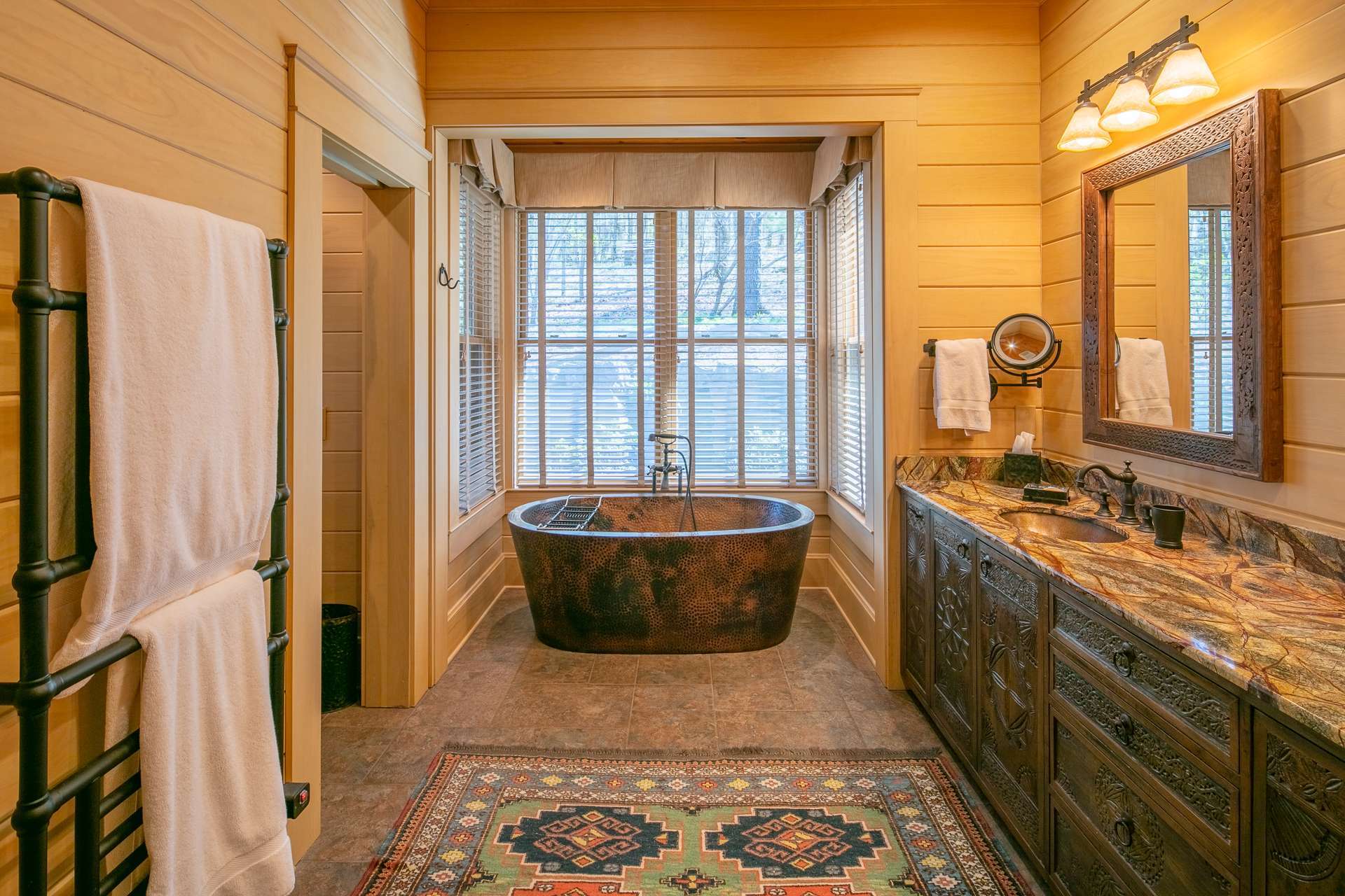 The luxurious master bath features unique carved cabinetry, hammered copper soaking tub and sinks, steam shower with six jets, heated floor and towel rack.