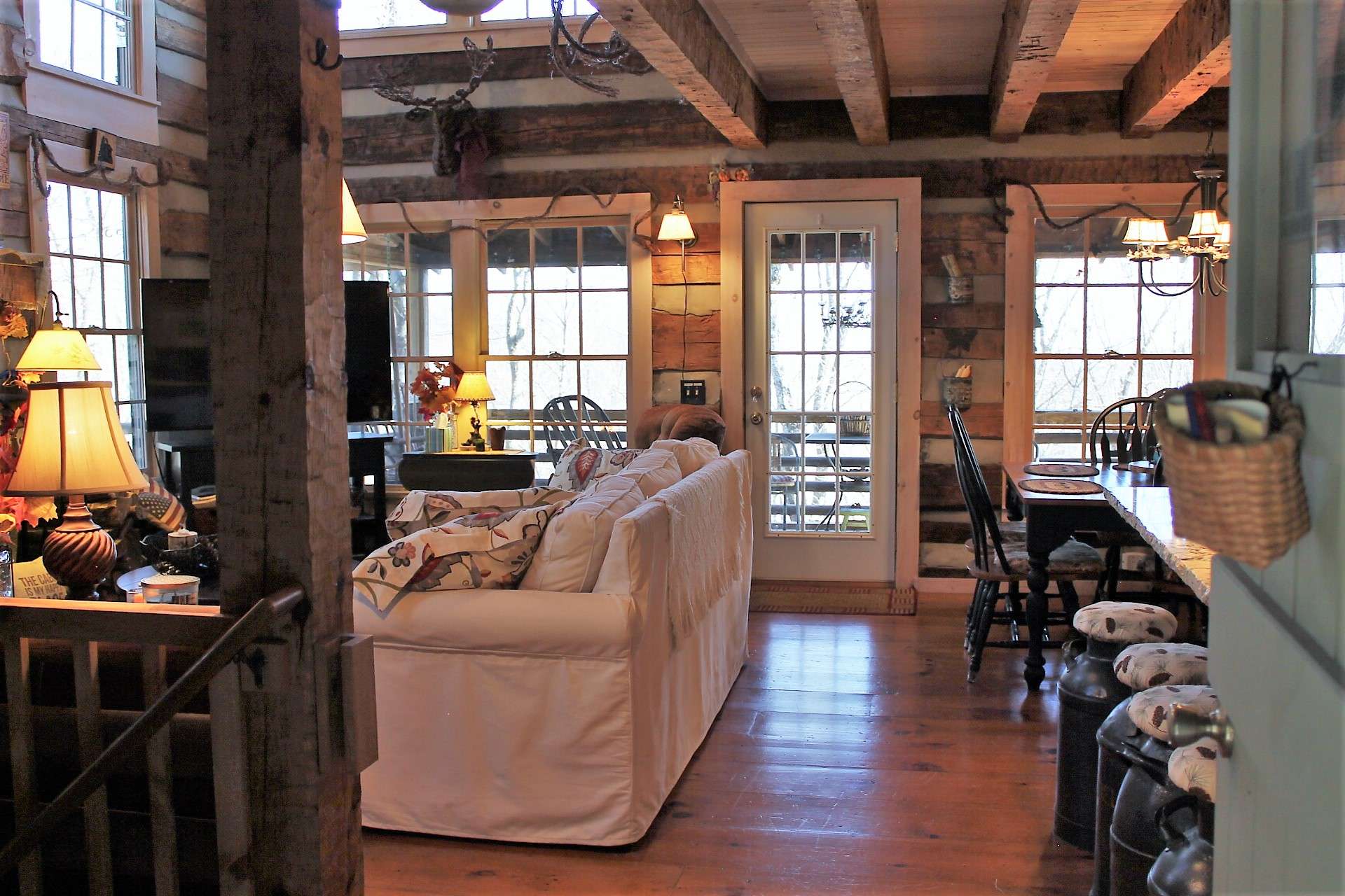 Entering the front door to the warm and inviting great room with access to screened porch.