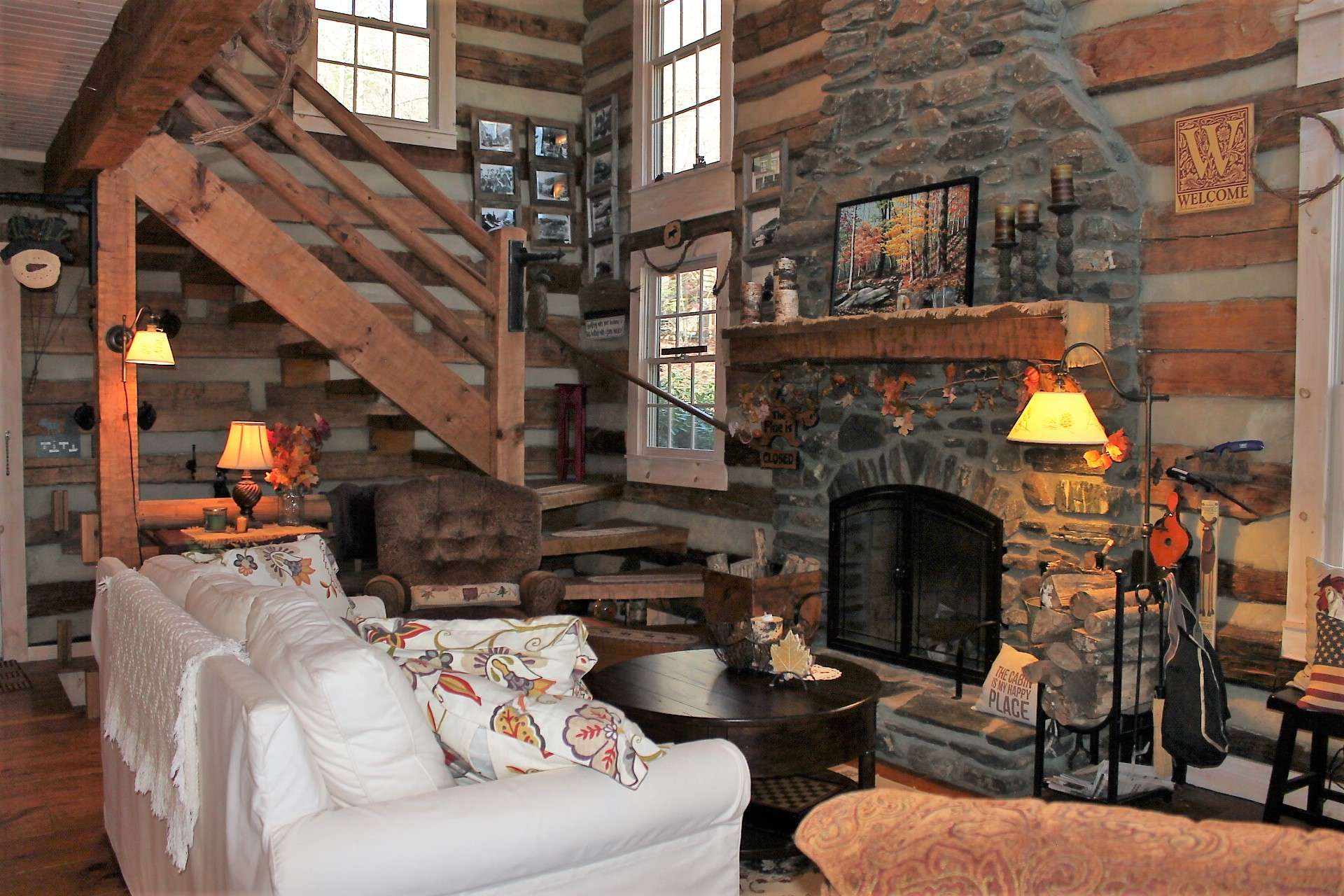 Notice the hand-hewn staircase that leads to the loft and the lower level.