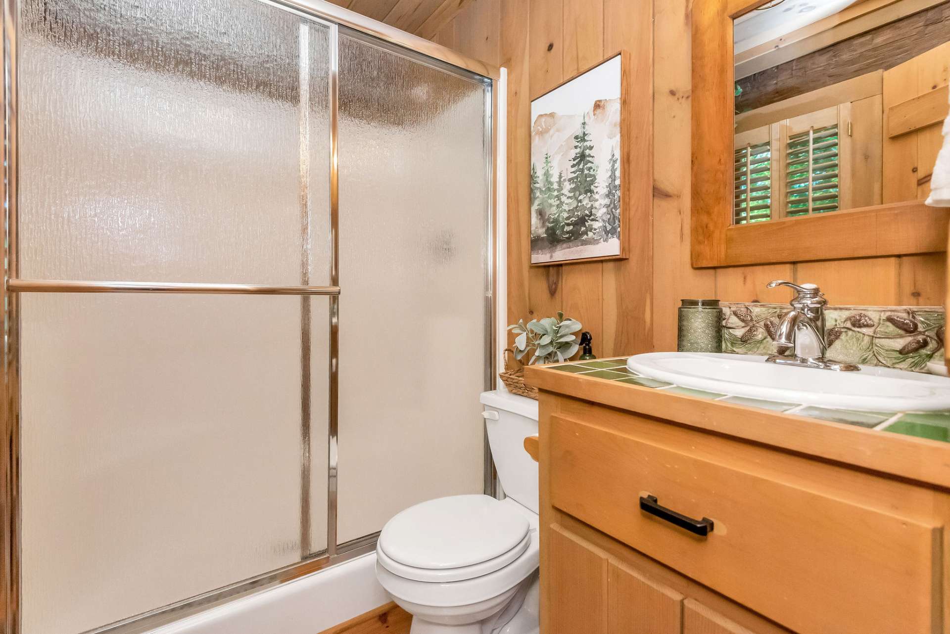 This bath is on the main level off of the kitchen area and has an easy step-in shower.