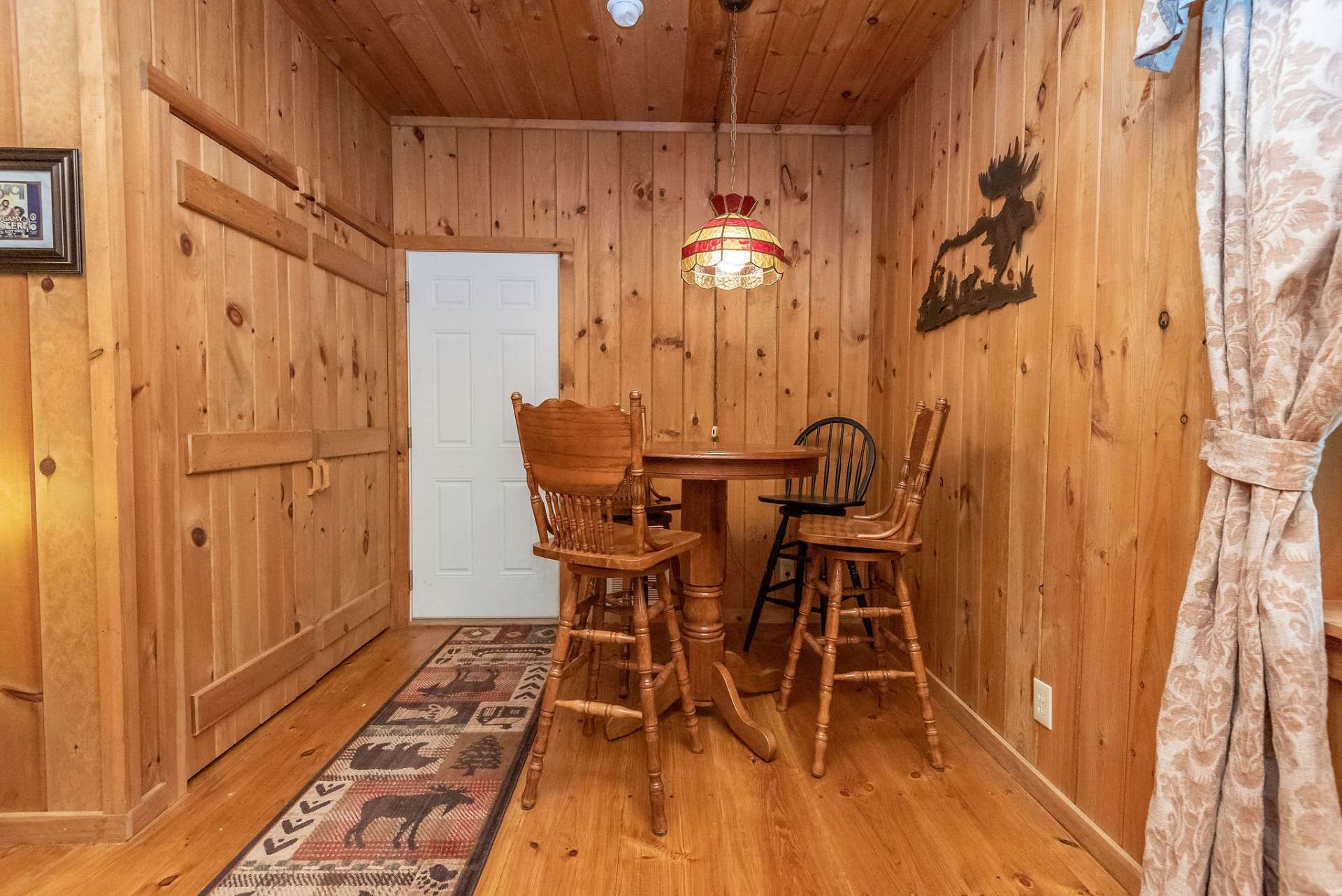 Laundry space with full size washer and dryer tucked behind double doors.