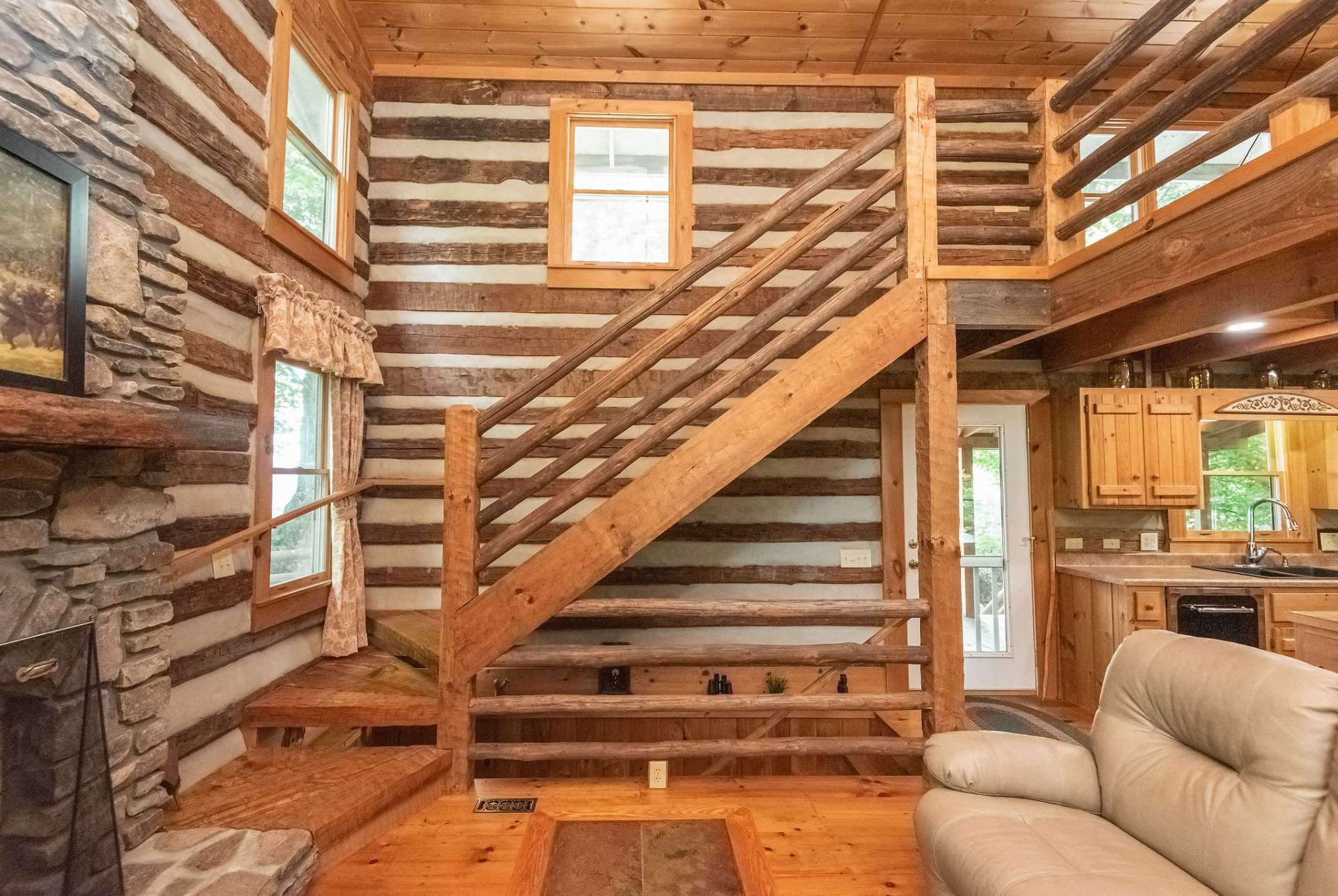 Custom hand hewn staircase leads to the spacious loft area.