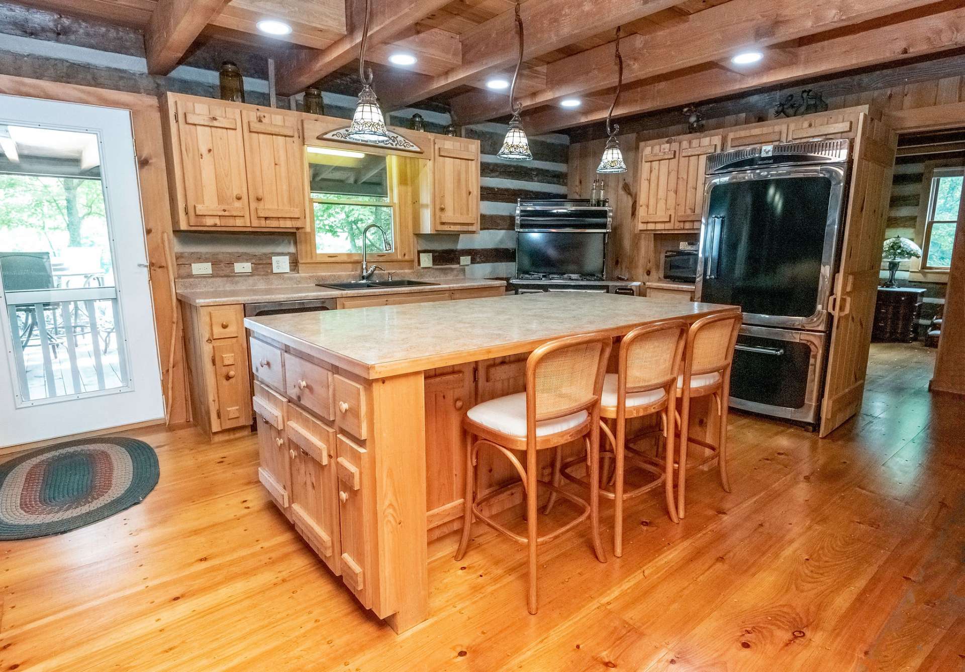 Kitchen features an oversized island with bar seating and storage on 3 sides.