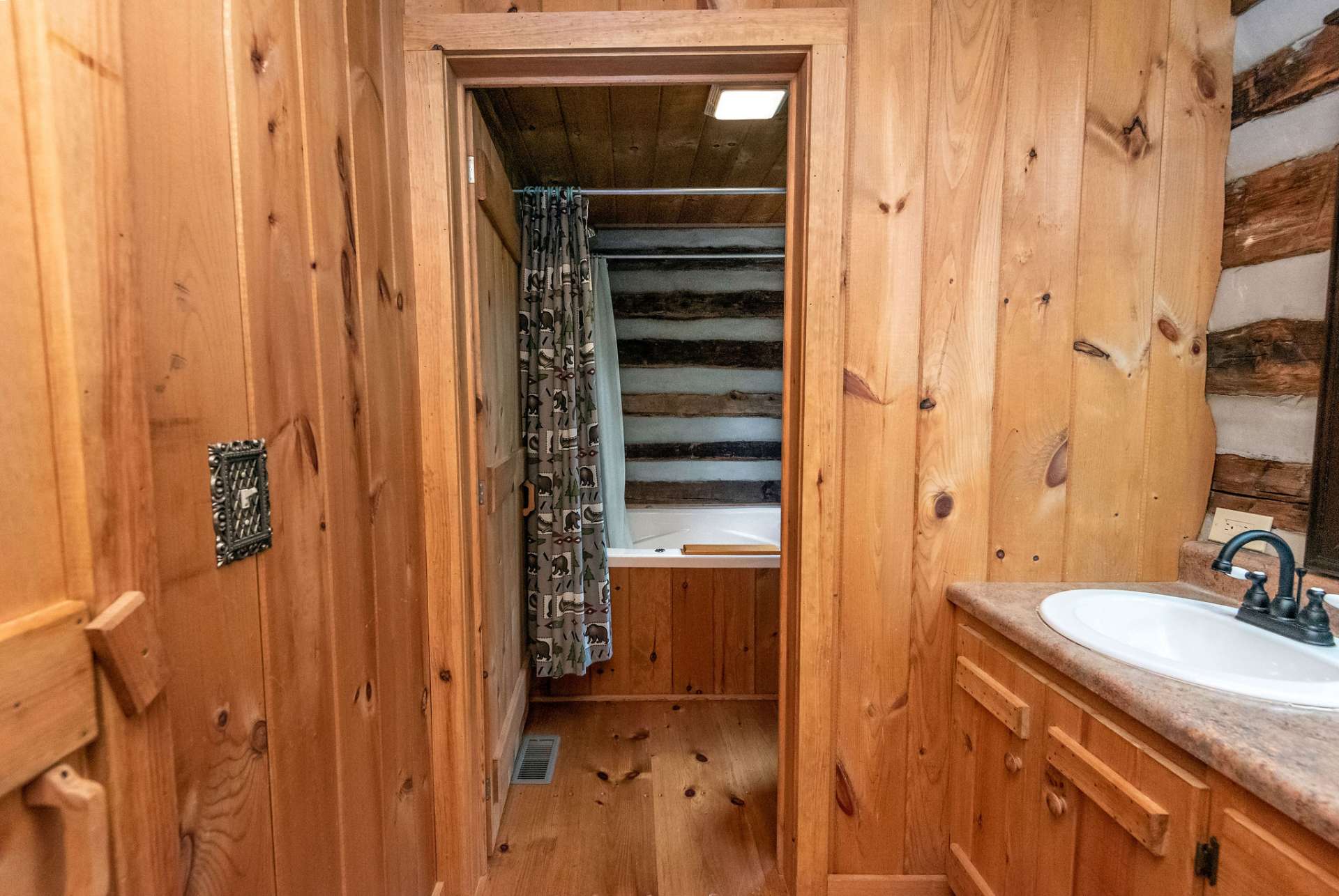 Private space for tub and toilet in main level bath.