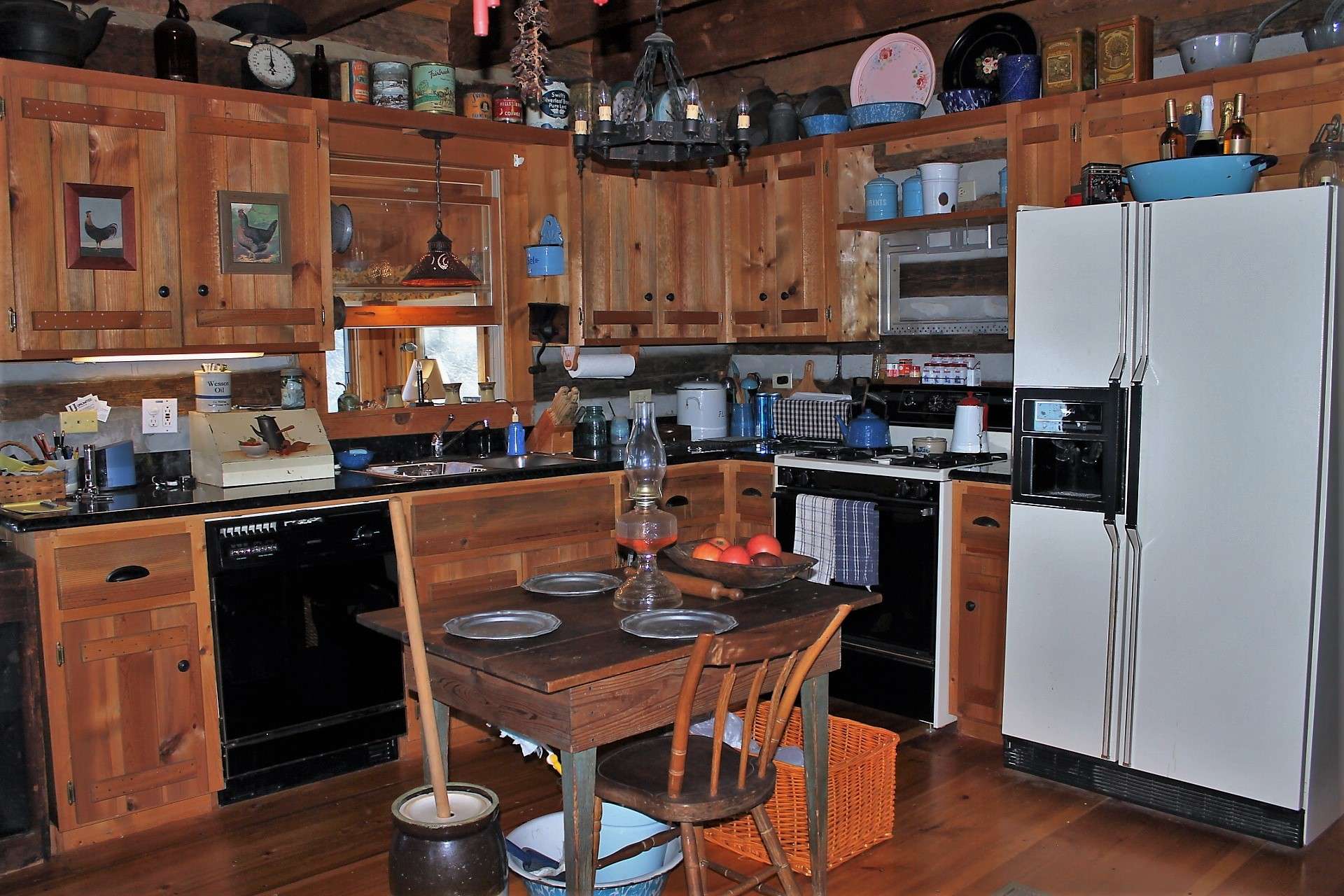 The kitchen features granite countertops with gas range and custom cabinetry with a convenient pass through to the sunroom.