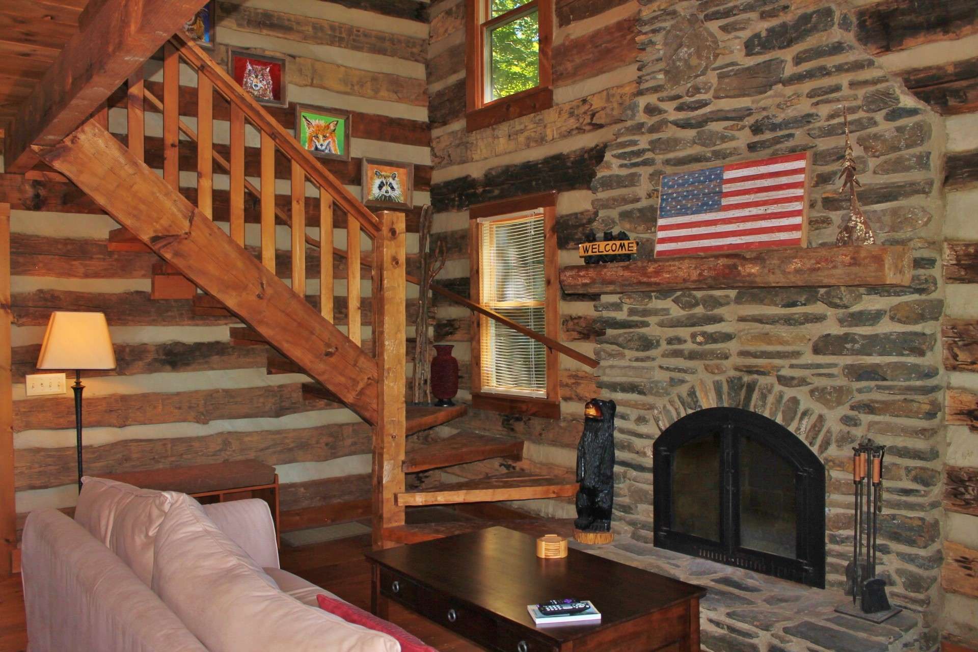 The fireplace is flanked by windows filling the space with natural light.