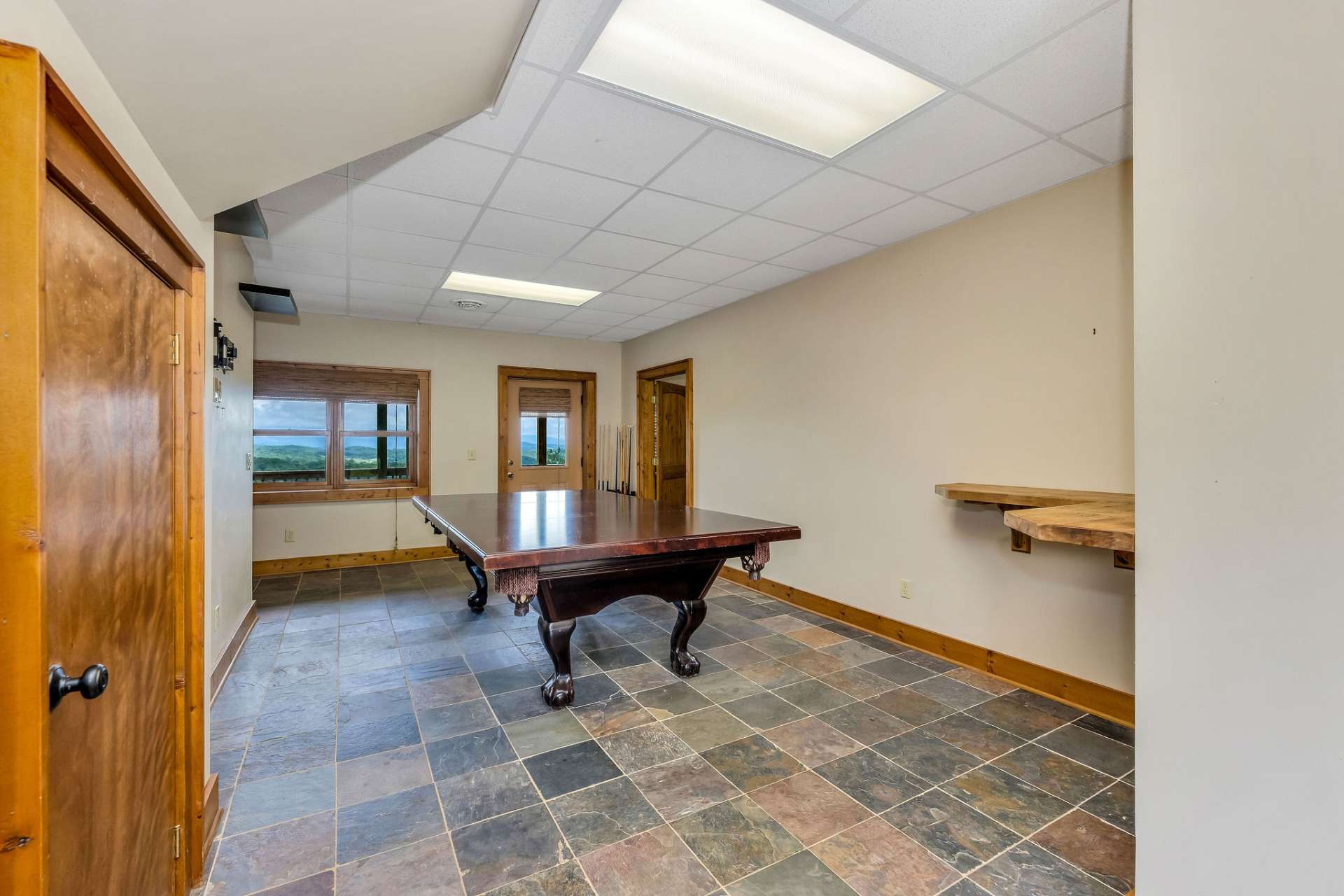 View from the laundry toward the pool table...the hot tub sets just outside the door and look at that view.