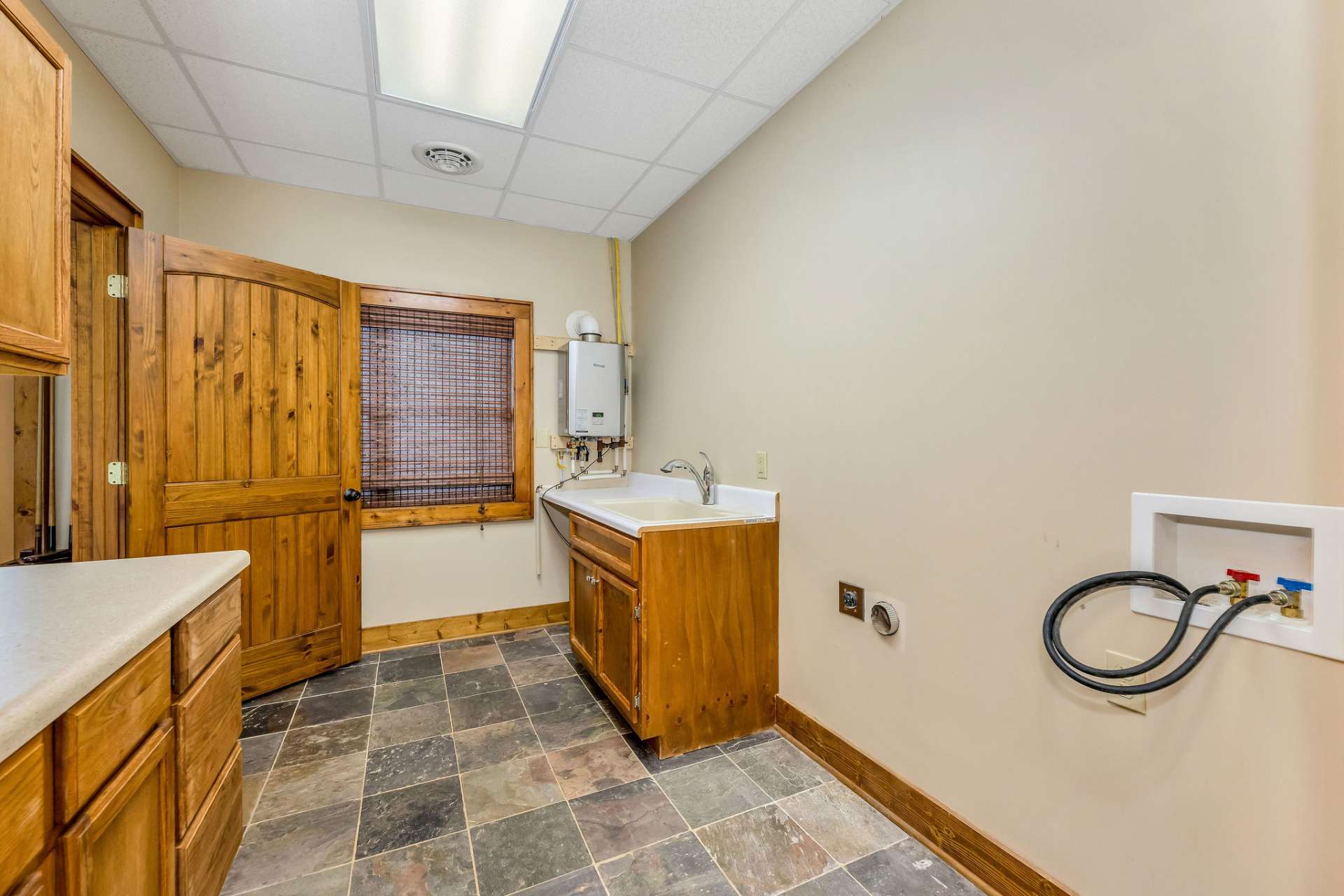 An oversized laundry room with no shortage of storage or you could move your appliances up to the mudroom upstairs.