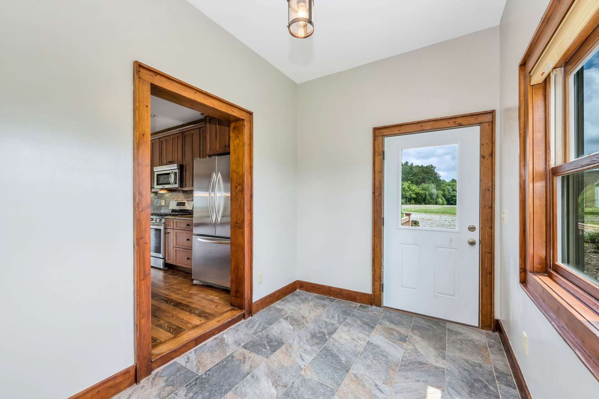 Entrance to the kitchen from an oversized mud room provides easy access to the grilling porch from the kitchen