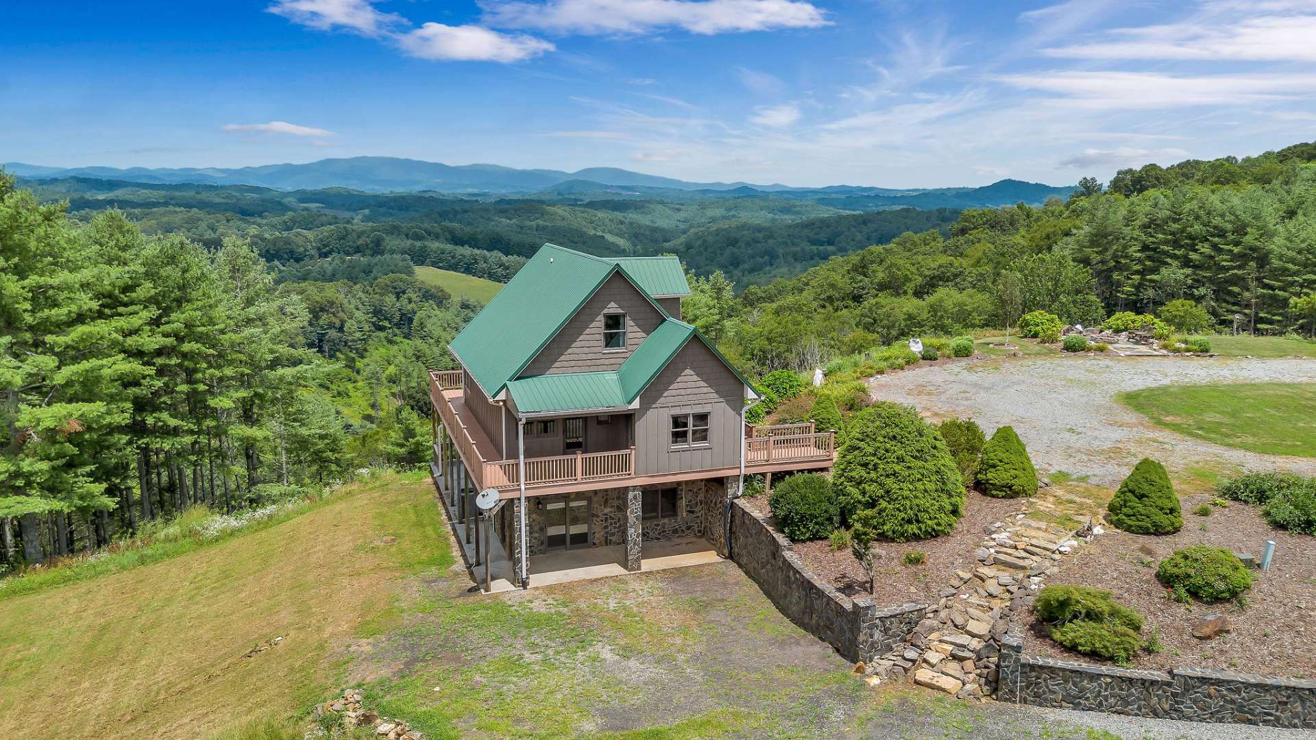 The covered back deck, upstairs bedroom deck, and hot tub all face a multi-layered view of the Virginia mountains