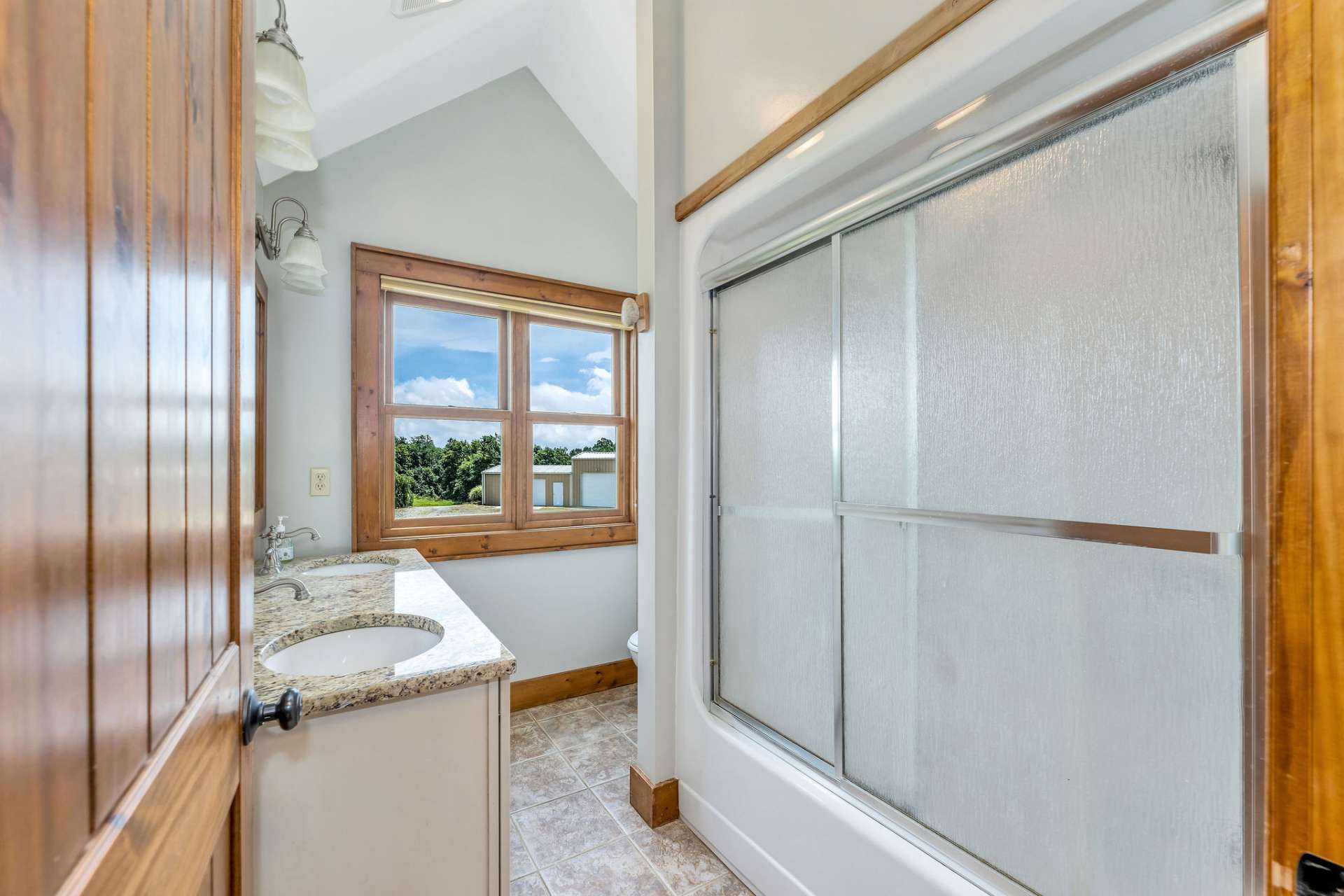 Second level bathroom with full tub/shower and double sink vanity