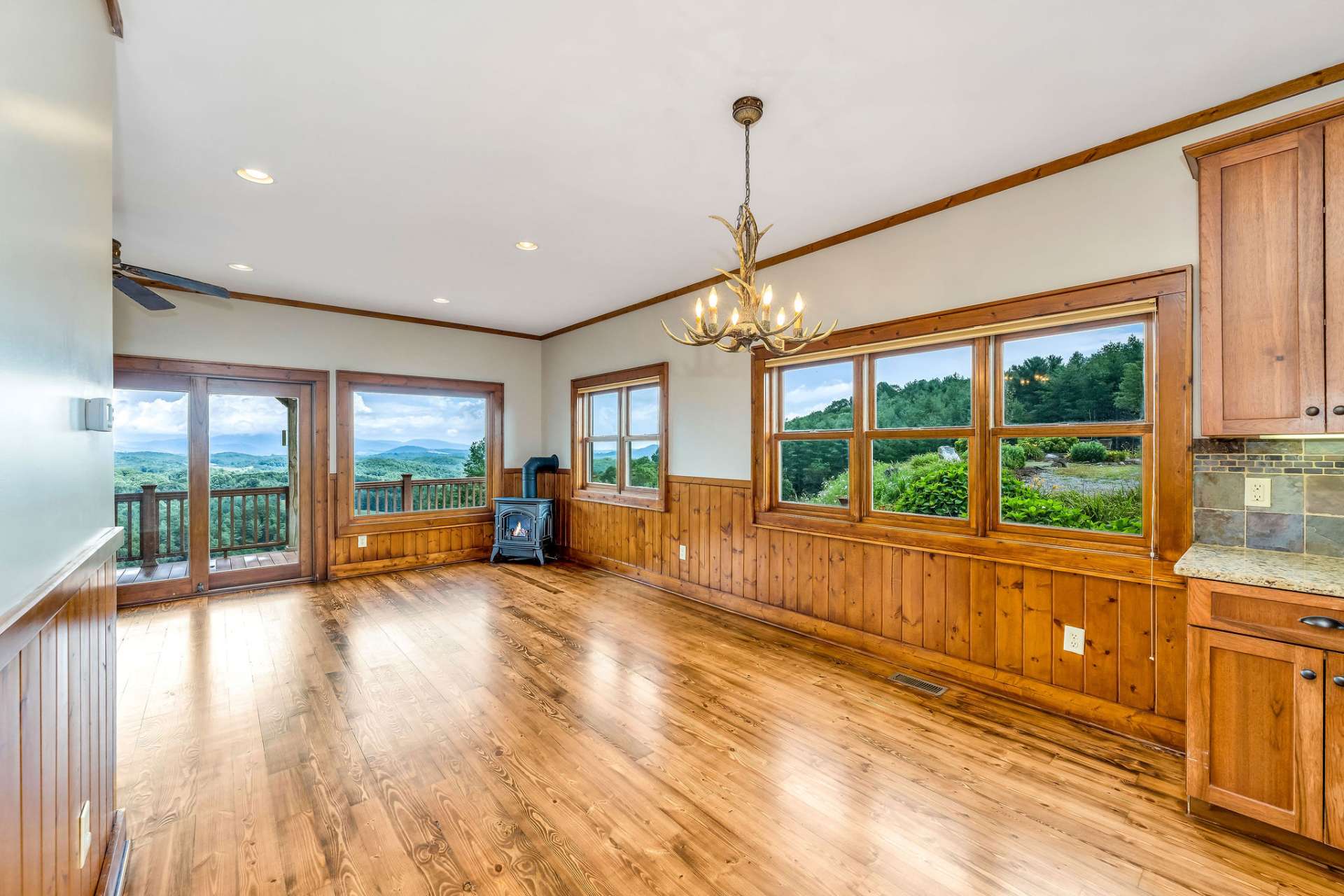 Custom lighting and a view of the perennial flowers from your dining area