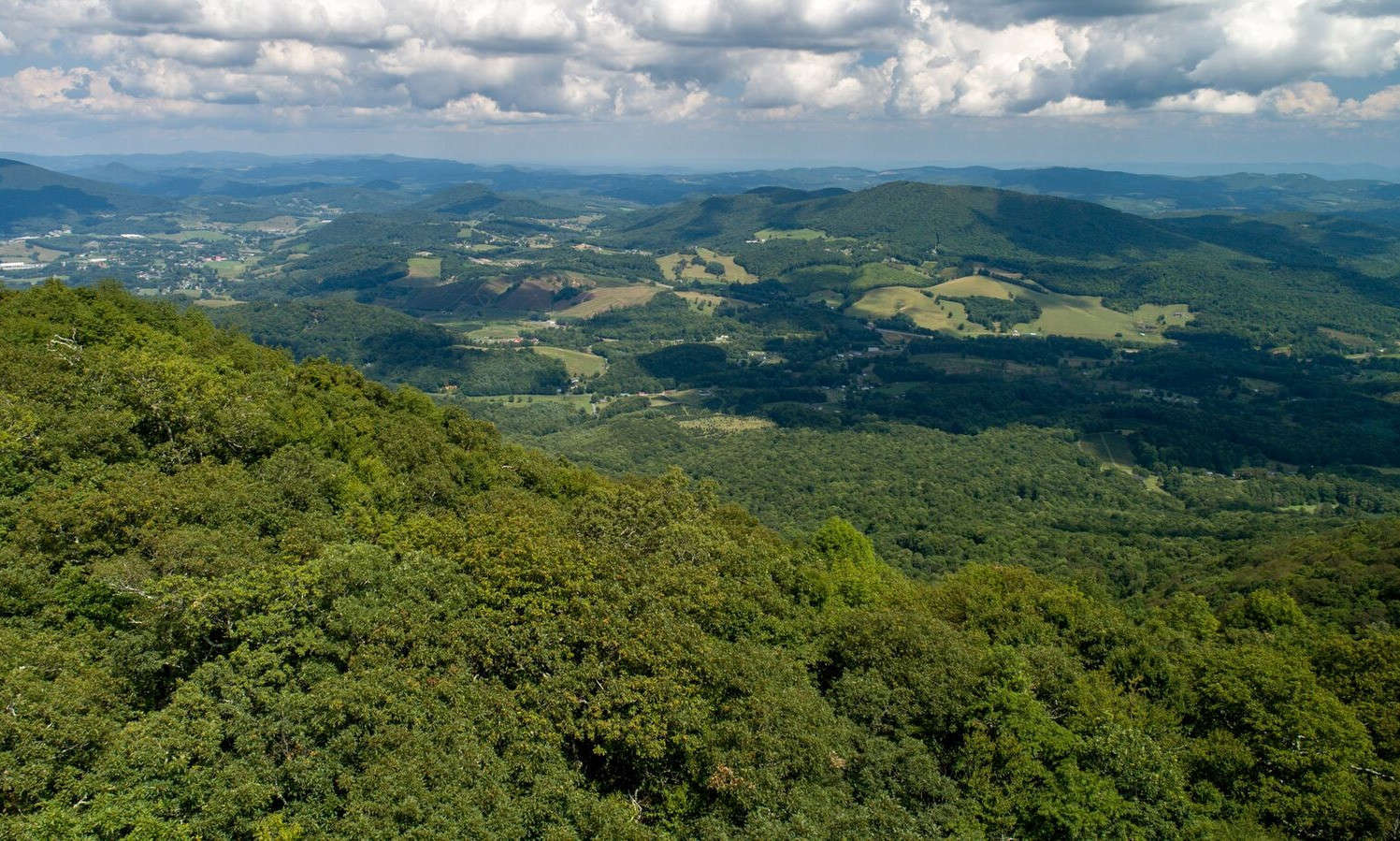 At 4,942 feet above sea level, this 11.01 acre mountain top has magnificent 360 degree long-range, layered mountain views into TN, VA and NC vistas, distinctive topography, beautiful rock outcroppings and a diverse mixture of native trees and plants.