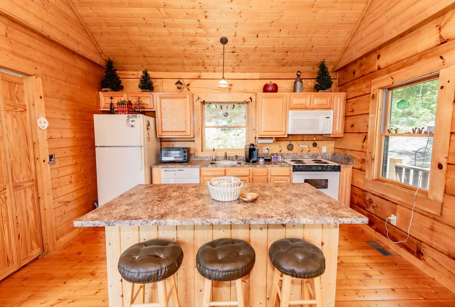 Ample work and storage space in the kitchen includes a center work island with bar seating.