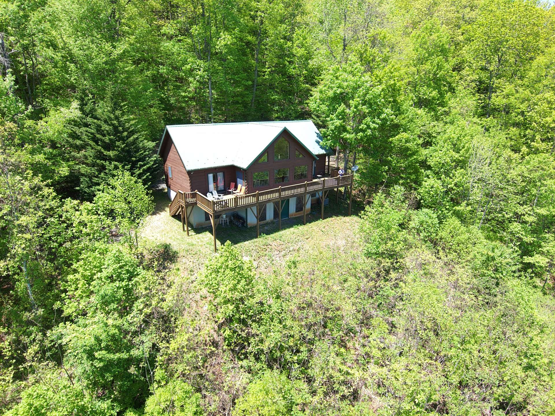 The 13.7 acre setting offers privacy along with a diverse mixture of hardwoods, evergreens, and native mountain foliage.