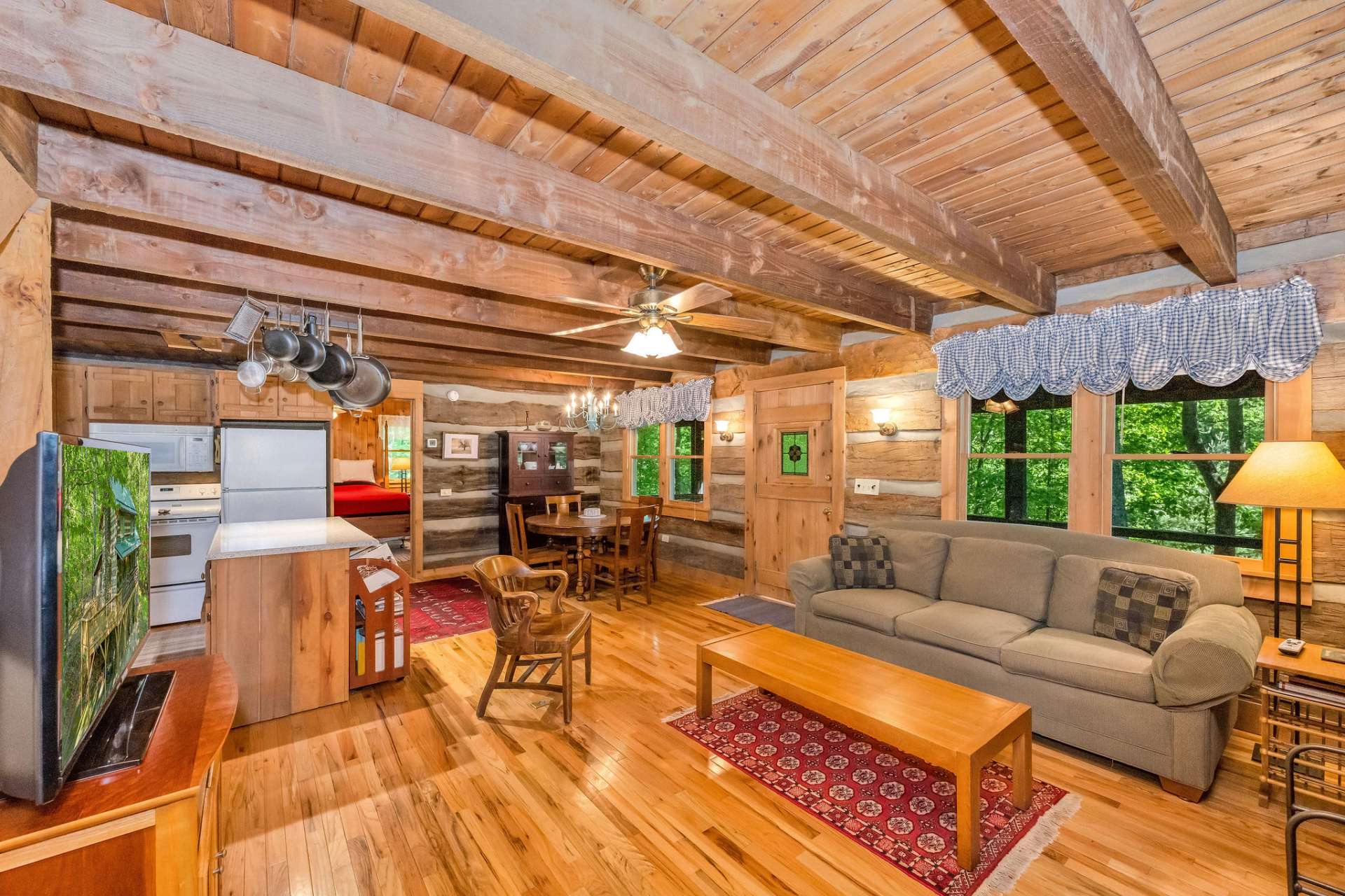 Warm hardwood flooring unifies the entire main level.