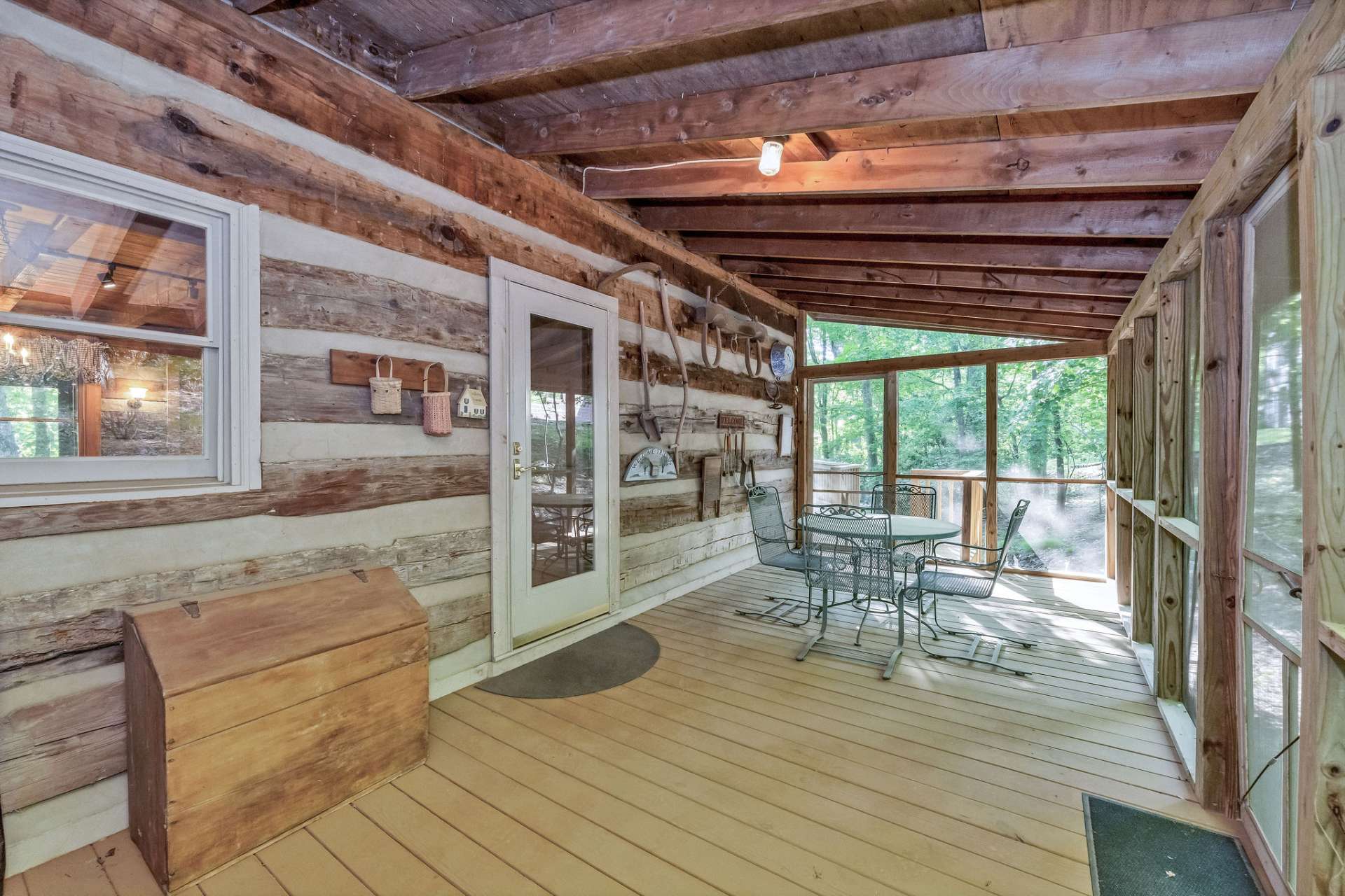 The screened porch lives like an outdoor living room, perfect for morning coffee or sunset cocktails.